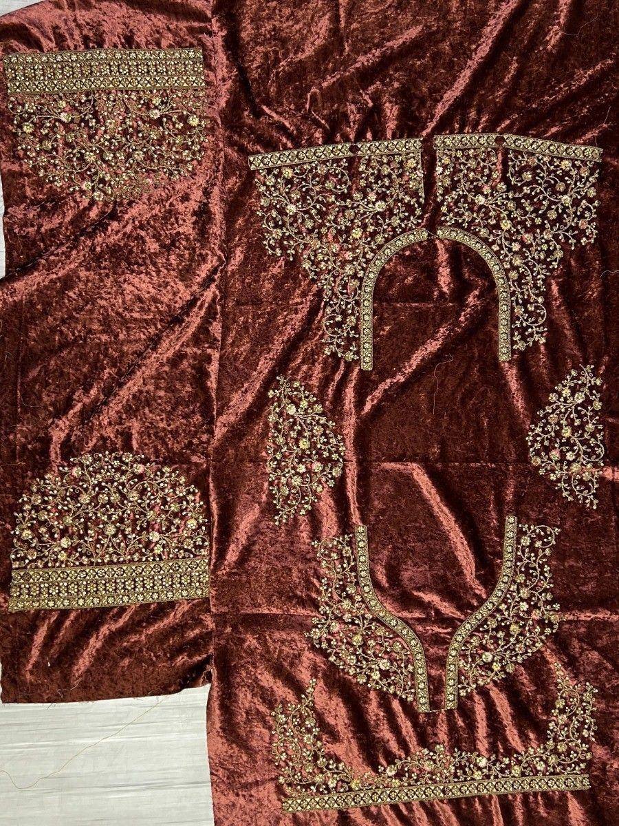 Rich maroon velvet ethnic gown with intricate gold floral embroidery and embellished neckline details