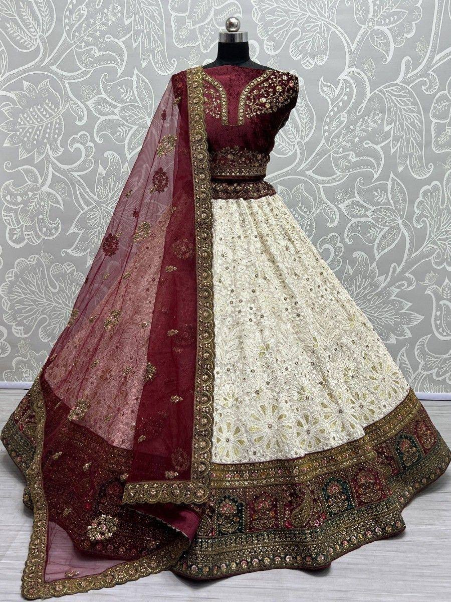 Maroon and ivory designer lehenga choli with gold embroidery and sheer dupatta, perfect for weddings and festivals.