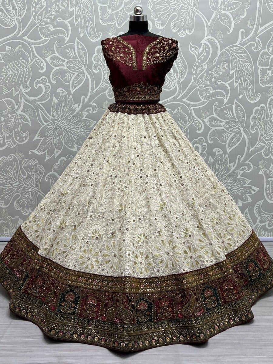 Maroon and cream embroidered lehenga choli with floral lace skirt and gold detailing, perfect for Indian weddings.