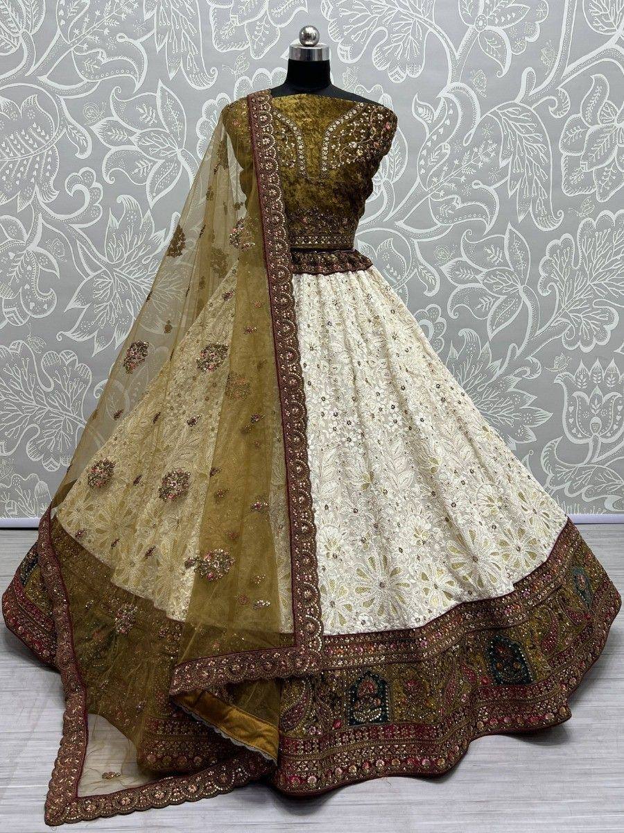 Elegant cream and olive green embroidered lehenga choli with sheer dupatta, perfect for Indian weddings and festivals.