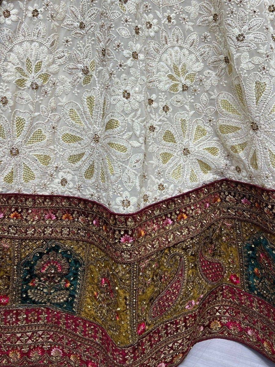White embroidered lehenga with gold floral motifs and colorful sequined border, ethnic Indian wear