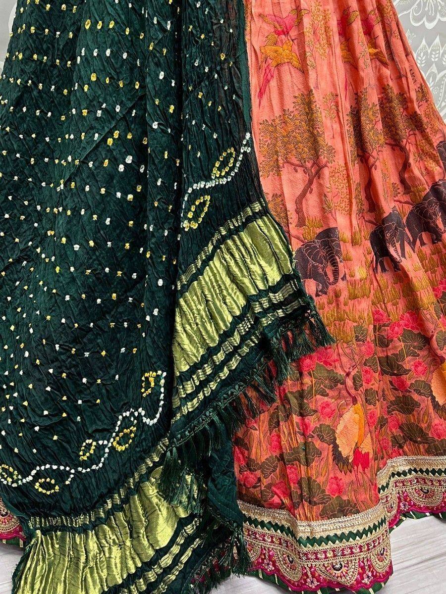Green and coral Indian ethnic lehenga with embroidery, mirror work, and elephant print details
