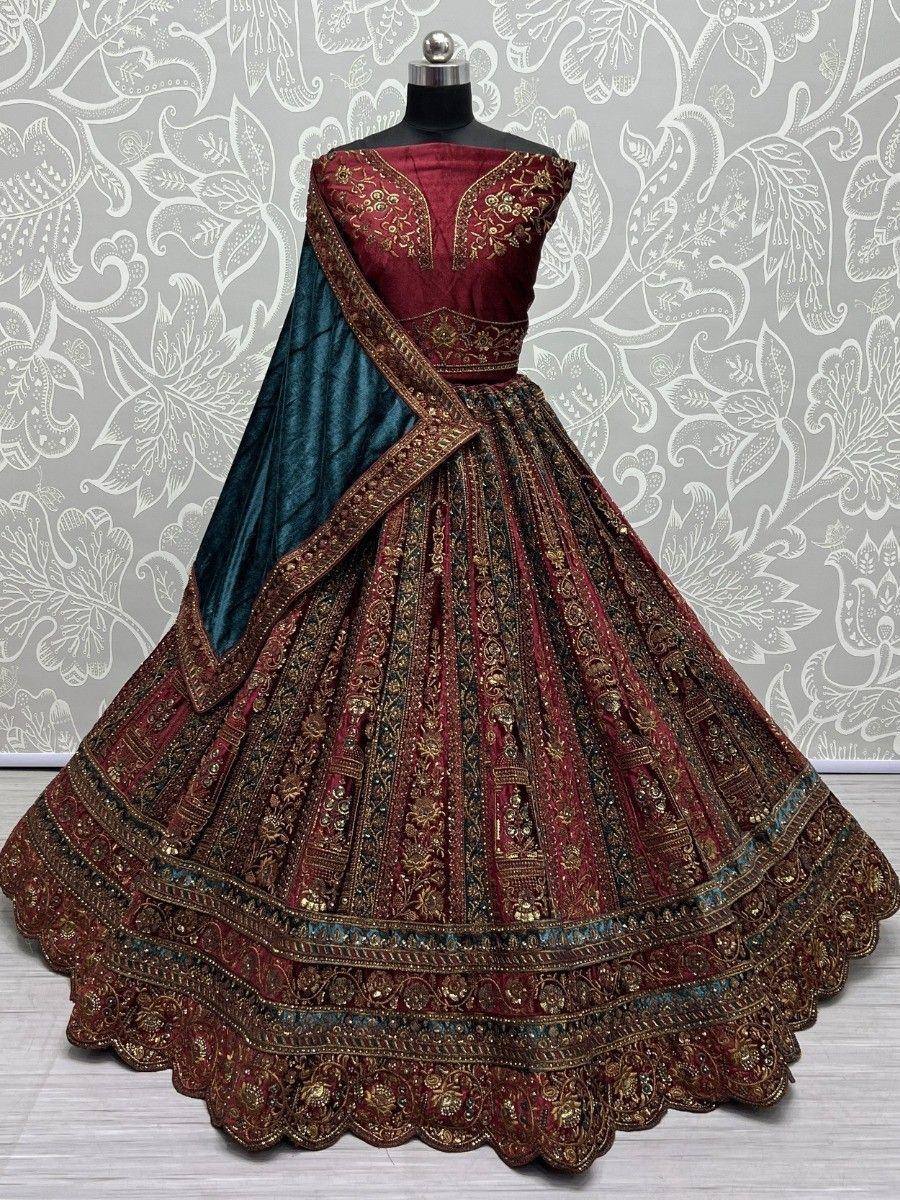 Maroon and teal designer lehenga choli with gold embroidery, perfect for Indian weddings and festive occasions.
