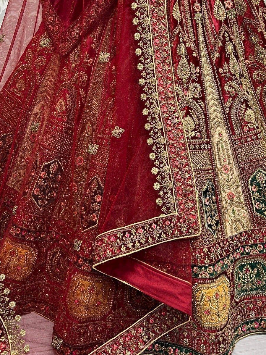 Rich maroon lehenga choli with intricate gold embroidery and floral motifs, perfect for Indian weddings.