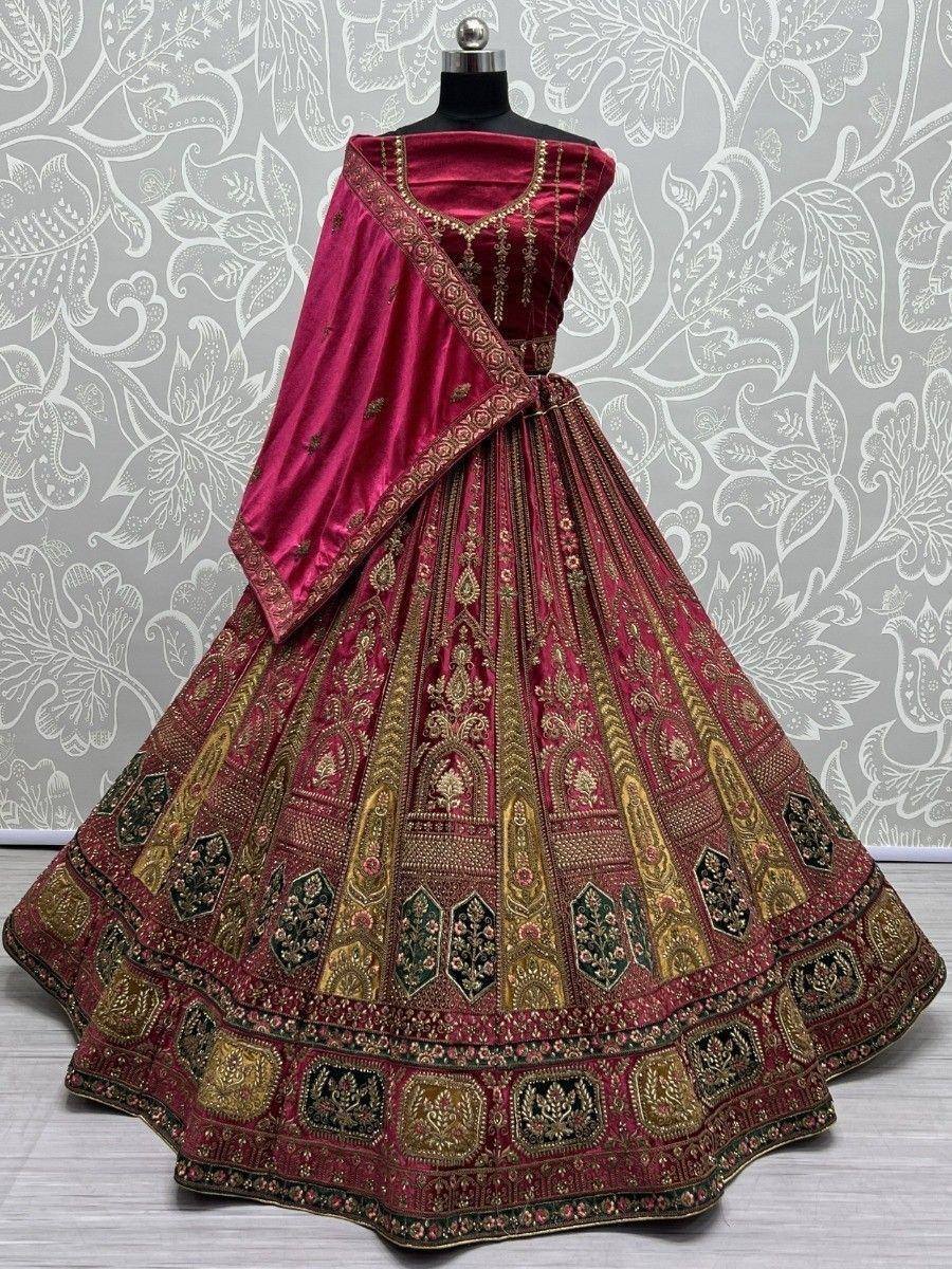 Luxury maroon velvet lehenga choli with gold embroidery, perfect for Indian weddings and festive occasions.