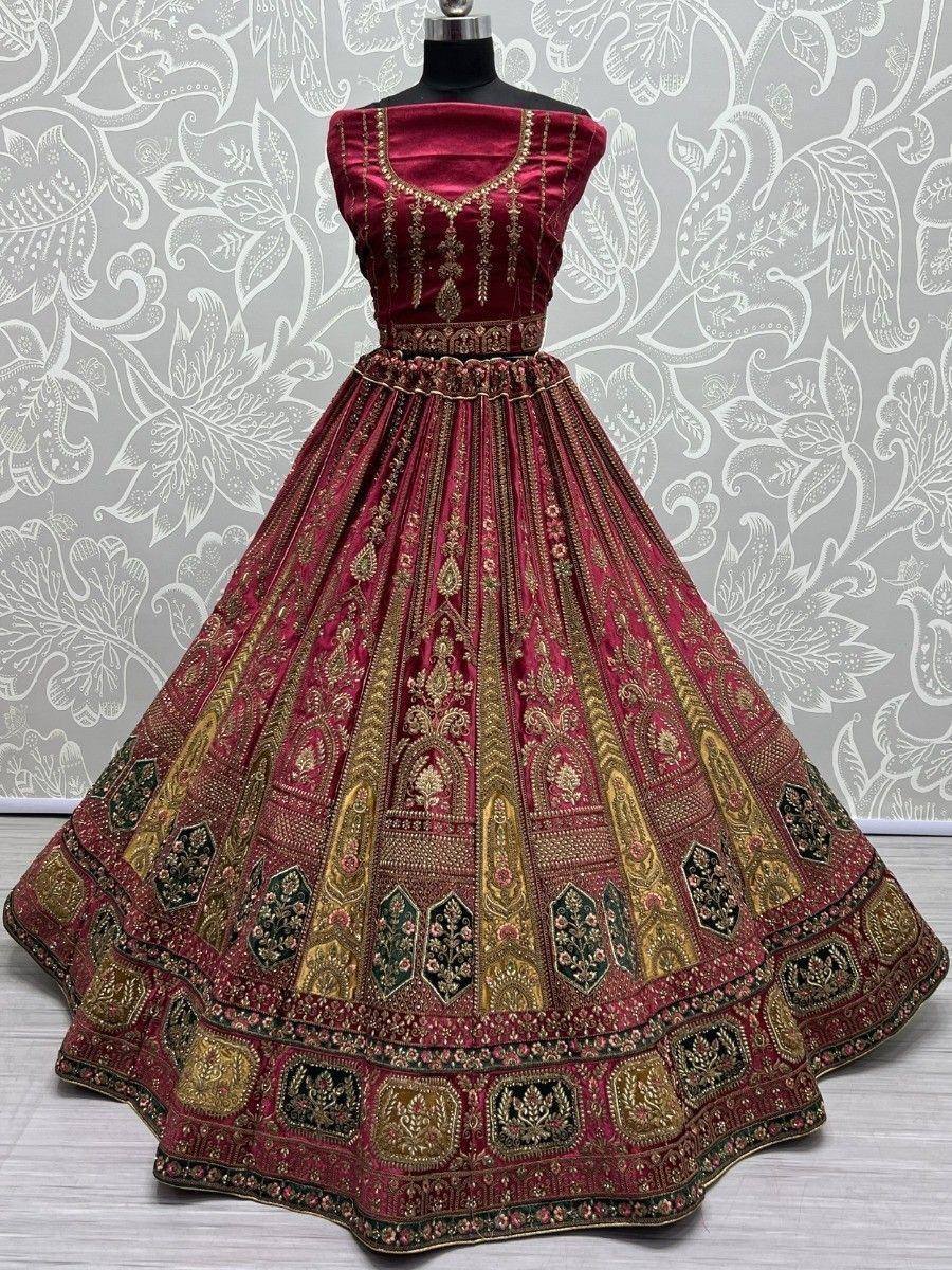 Maroon designer lehenga choli with gold embroidery, perfect for Indian weddings and festive occasions.