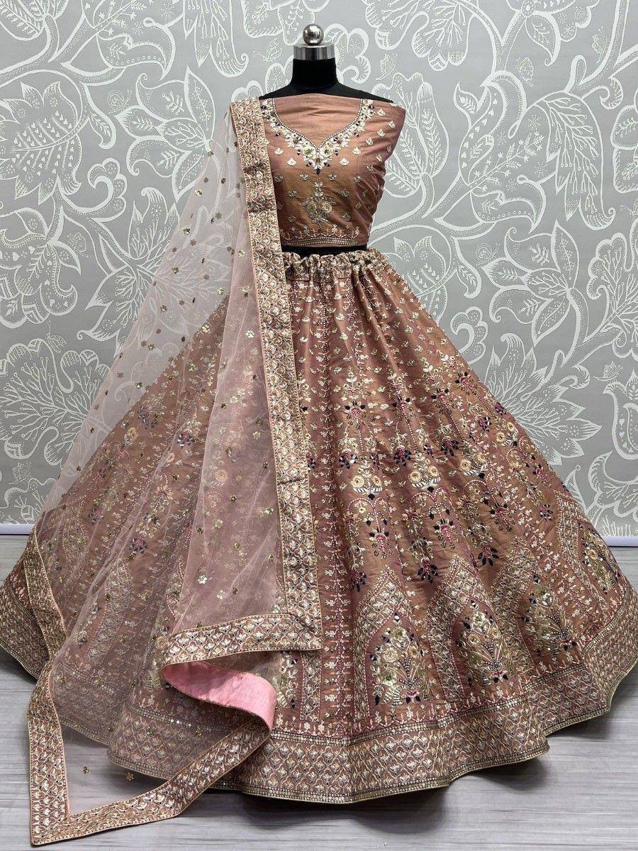 Elegant beige embroidered lehenga choli with floral motifs and sheer dupatta, perfect for Indian ethnic occasions.