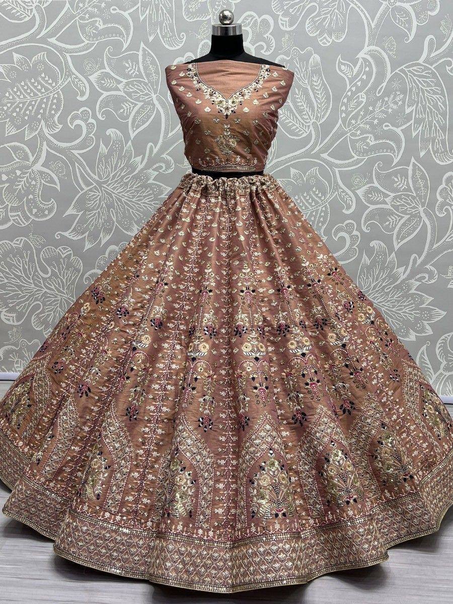 Elegant brown designer lehenga choli with intricate gold embroidery and floral patterns, perfect for Indian weddings.