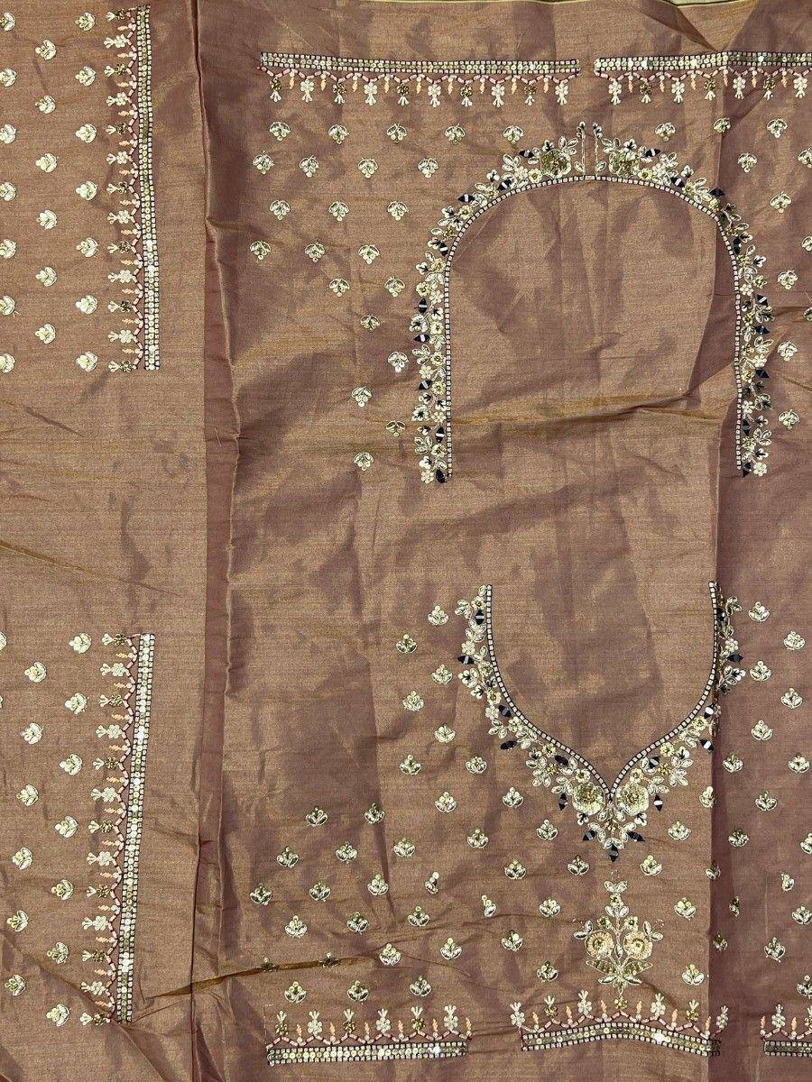 Brown ethnic salwar kameez with intricate gold and black embroidery, perfect for Indian festive wear.