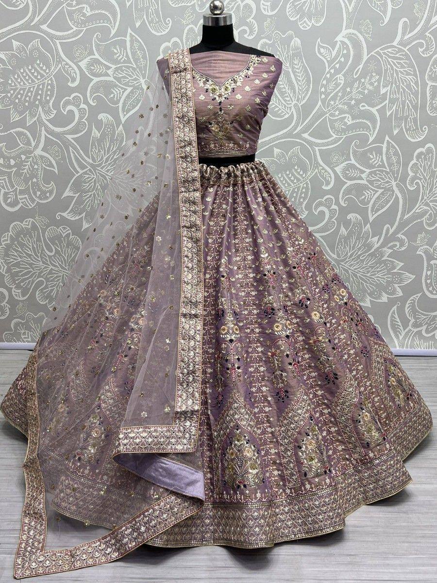 Elegant mauve lehenga choli with intricate gold embroidery and sheer dupatta, perfect for Indian weddings and festive occasions.
