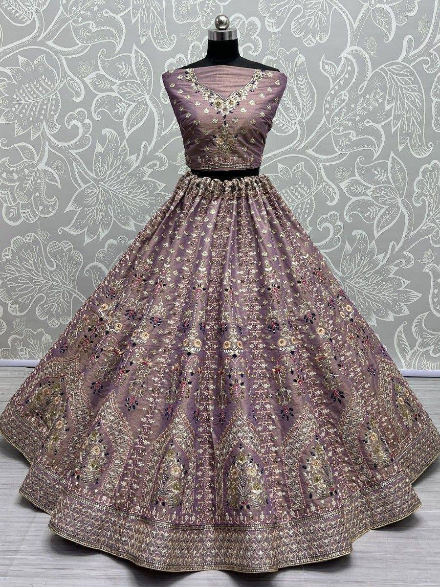 Elegant mauve lehenga choli with intricate gold embroidery, perfect for Indian ethnic occasions.