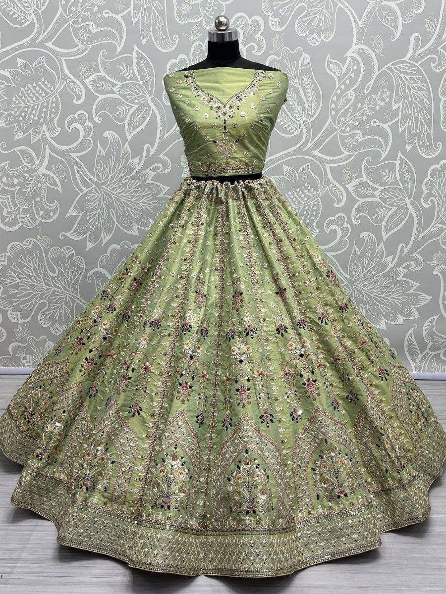 Light green designer lehenga choli with intricate floral embroidery and gold detailing, perfect for weddings and festivals