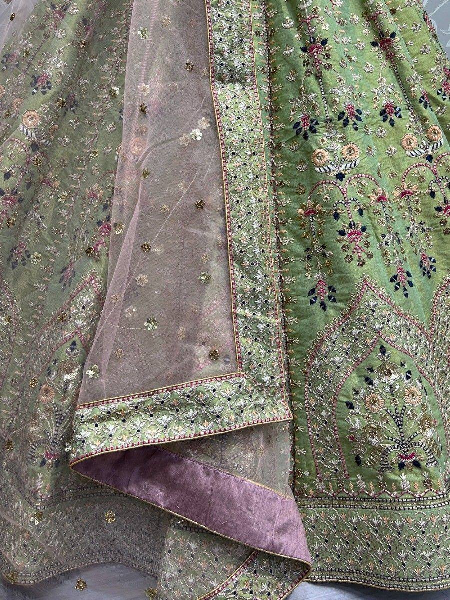 Green embroidered lehenga choli with sheer dupatta, floral motifs, and gold detailing for Indian ethnic wear