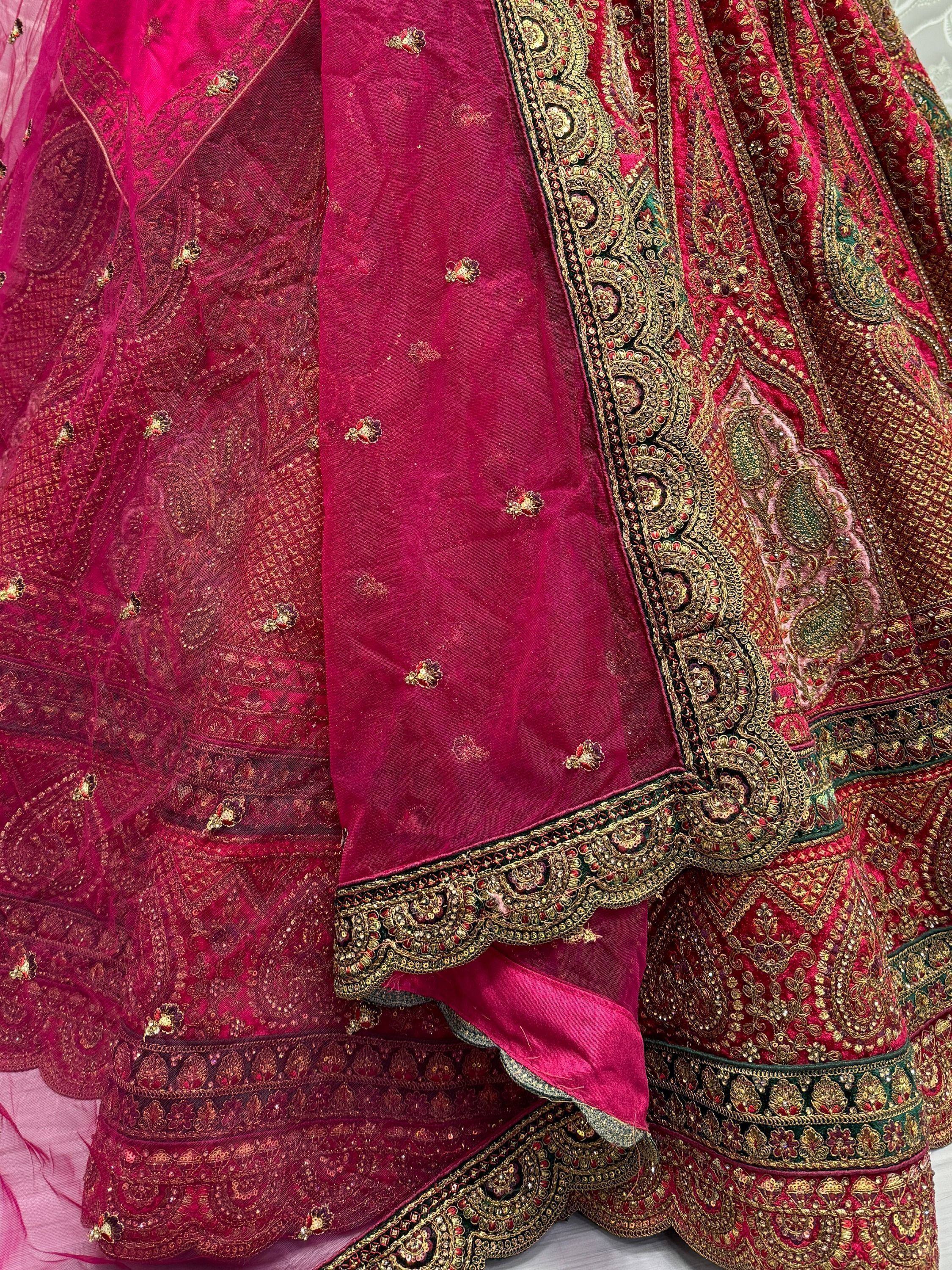 Luxury magenta lehenga choli with intricate gold embroidery and embellished dupatta for Indian ethnic wear