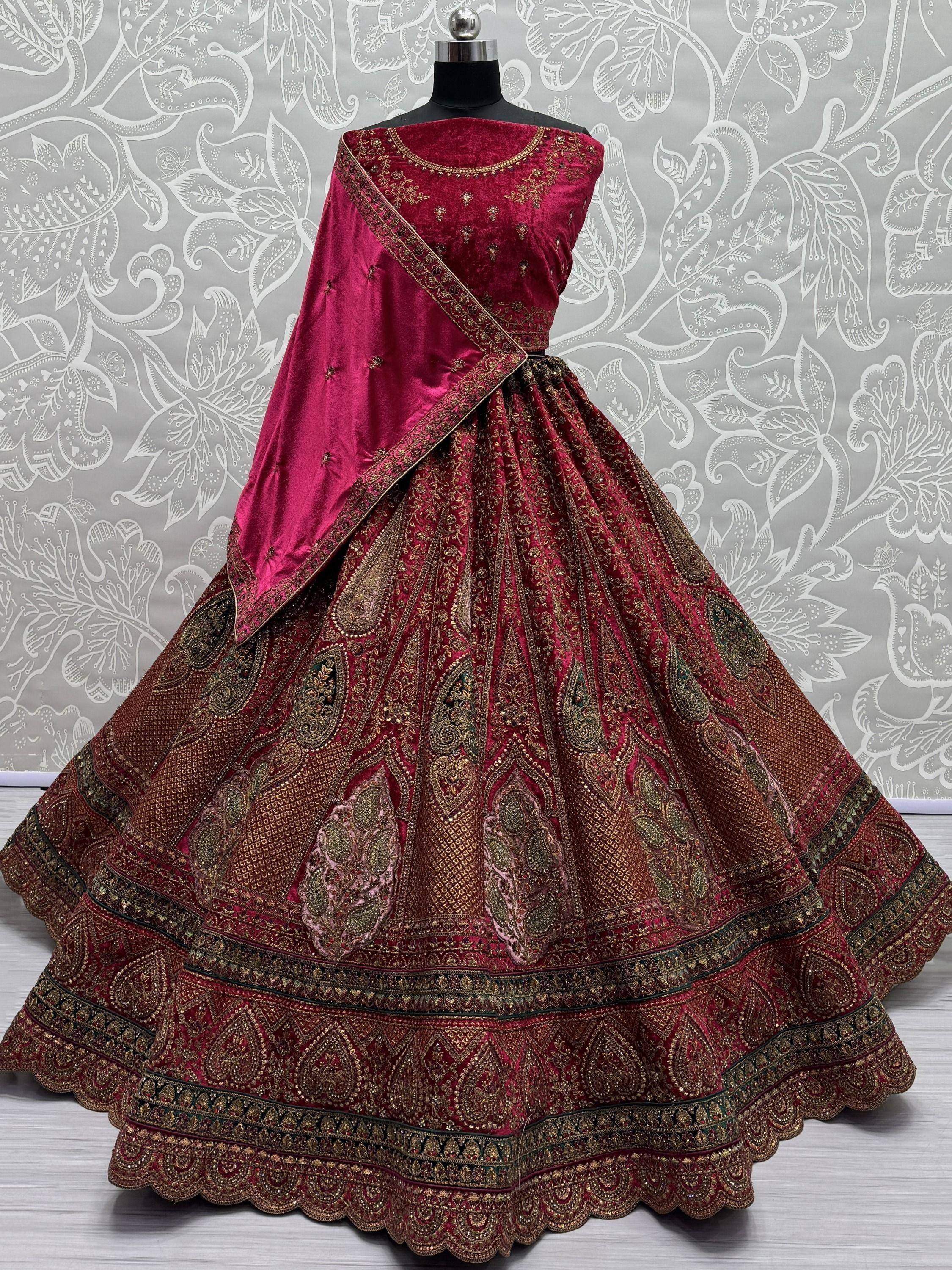 Luxury maroon velvet lehenga choli with gold embroidery, perfect for weddings and festive occasions