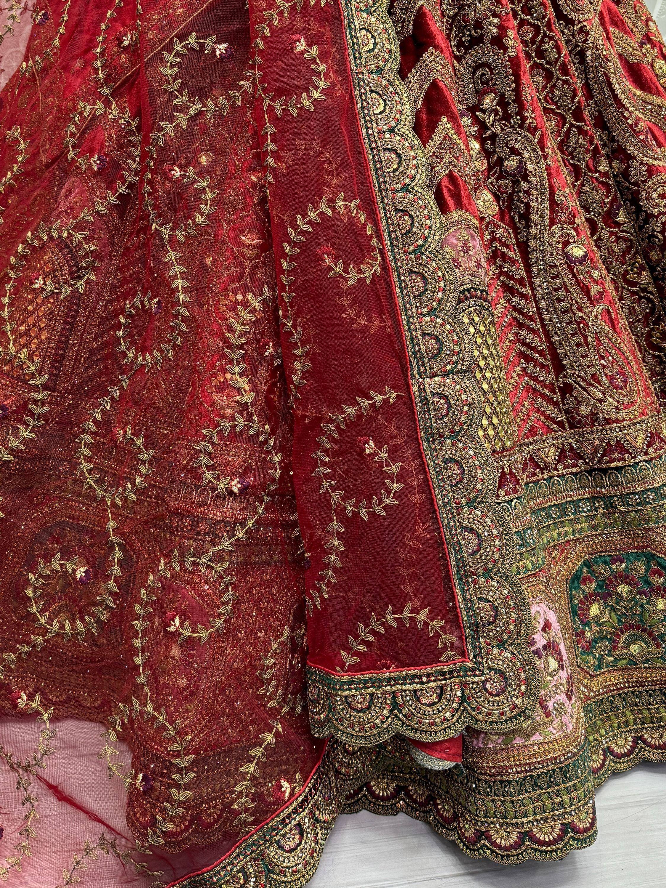 Luxury red lehenga choli with intricate gold embroidery and floral motifs, perfect for Indian weddings and festive occasions.