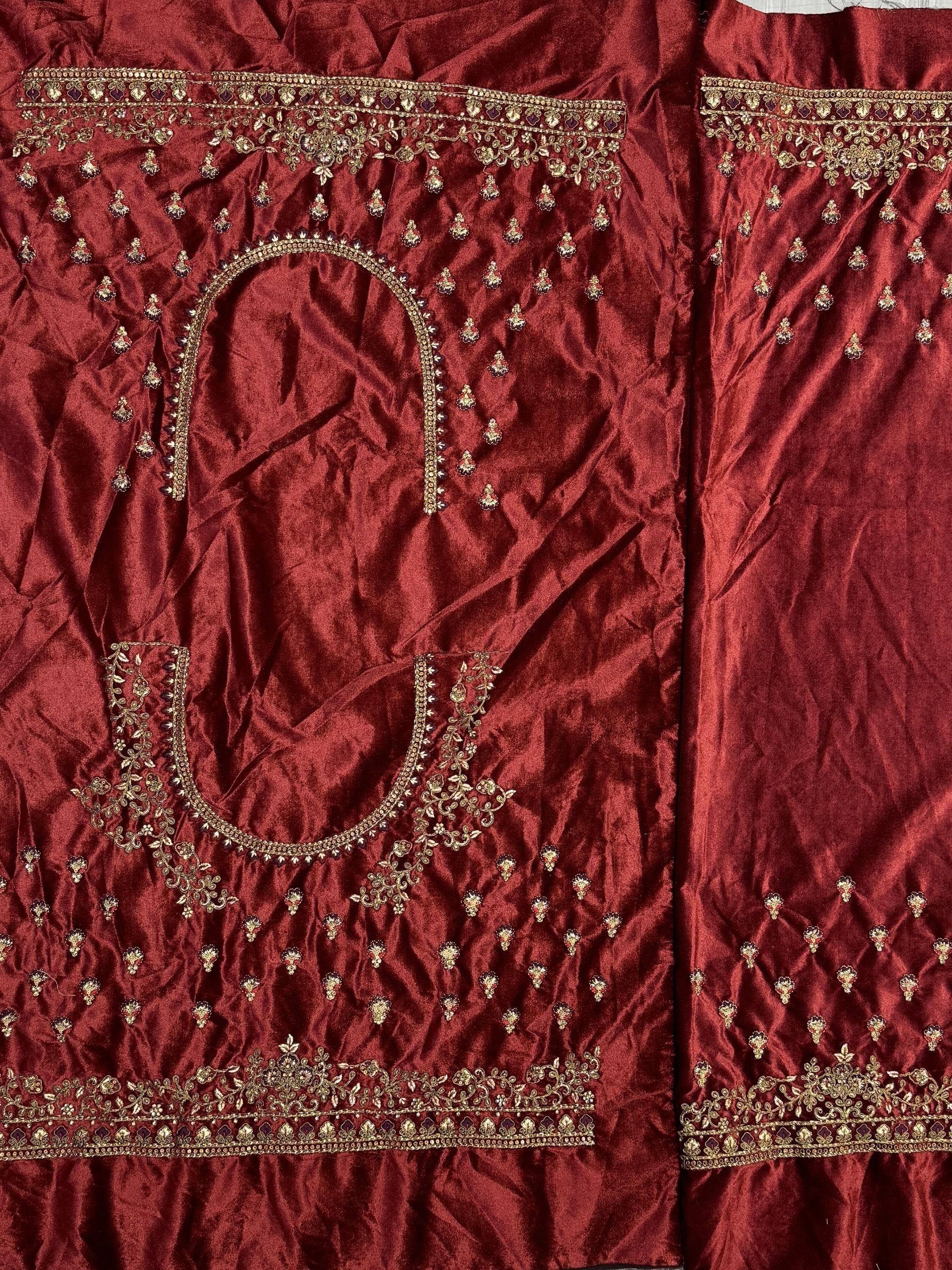 Rich maroon ethnic gown with gold embroidery and stone work, perfect for Indian celebrations