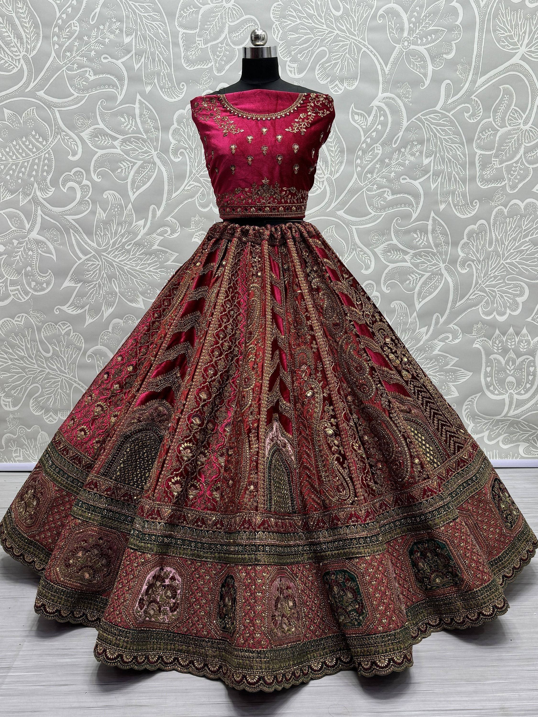 Maroon designer lehenga choli with gold embroidery, perfect for Indian weddings and festive occasions.