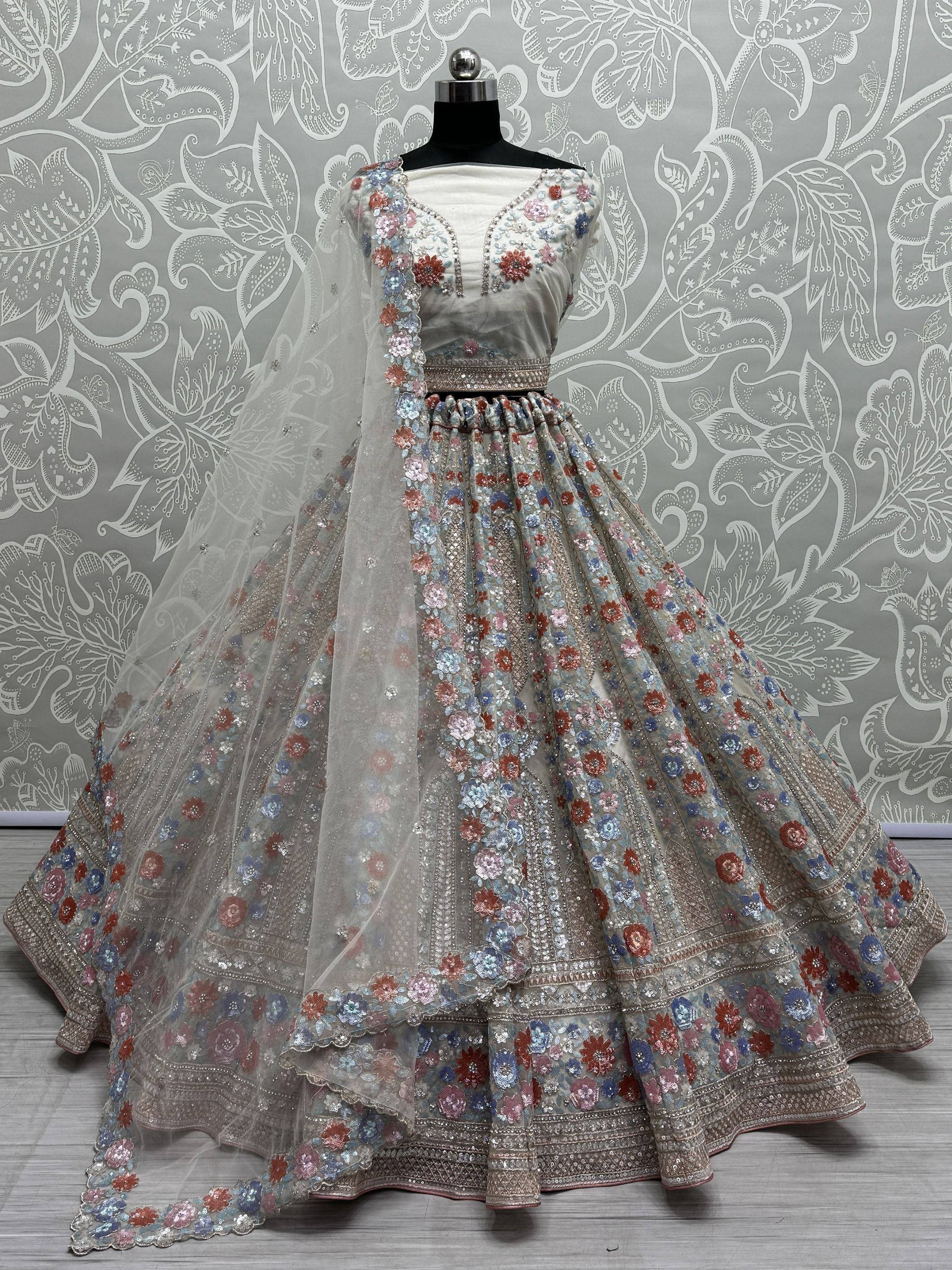 Designer lehenga choli with floral embroidery and net dupatta, perfect for Indian weddings and festive occasions.