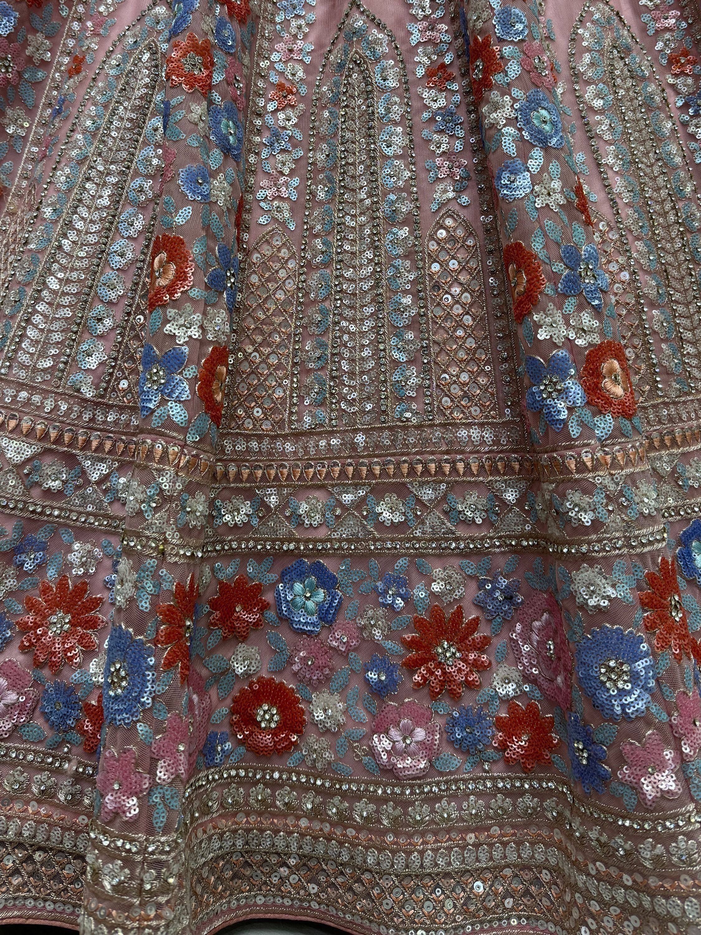 Pink floral sequin embroidered ethnic gown with blue and red flowers, perfect for Indian weddings or festive occasions.