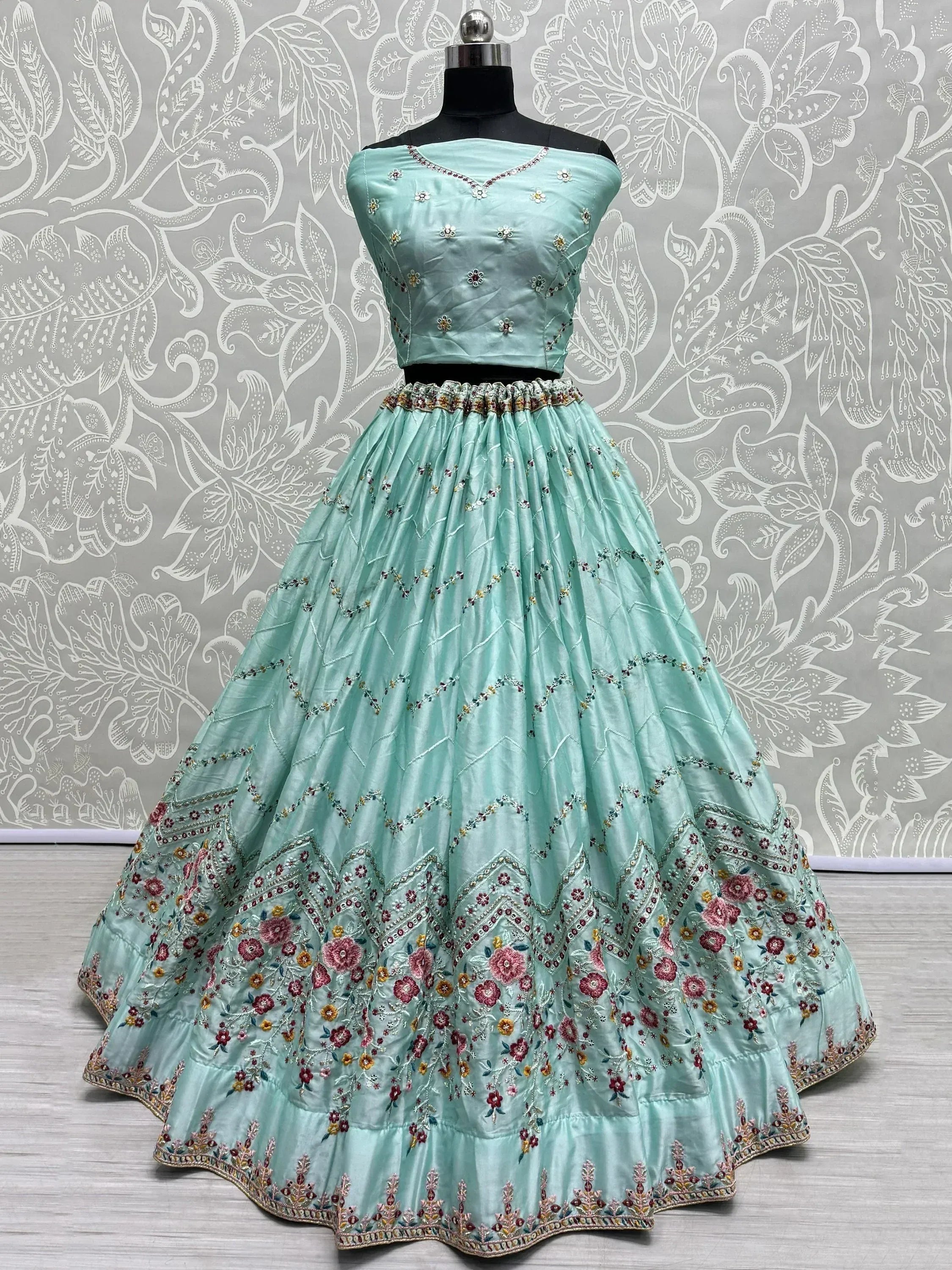 Mint green embroidered lehenga choli with floral motifs, perfect for Indian ethnic wear occasions