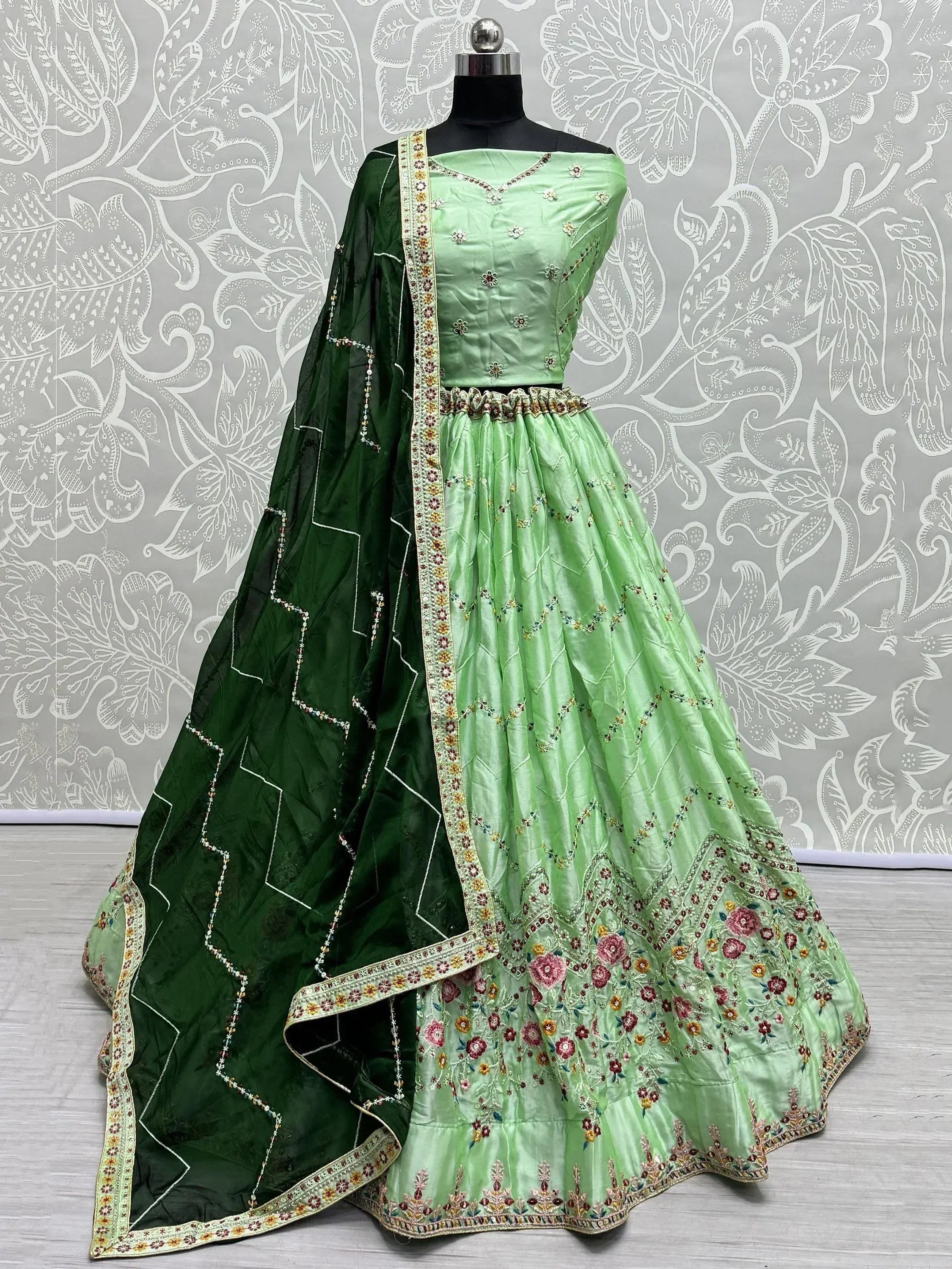 Light green embroidered lehenga choli with dark green dupatta, floral motifs, perfect for Indian ethnic wear