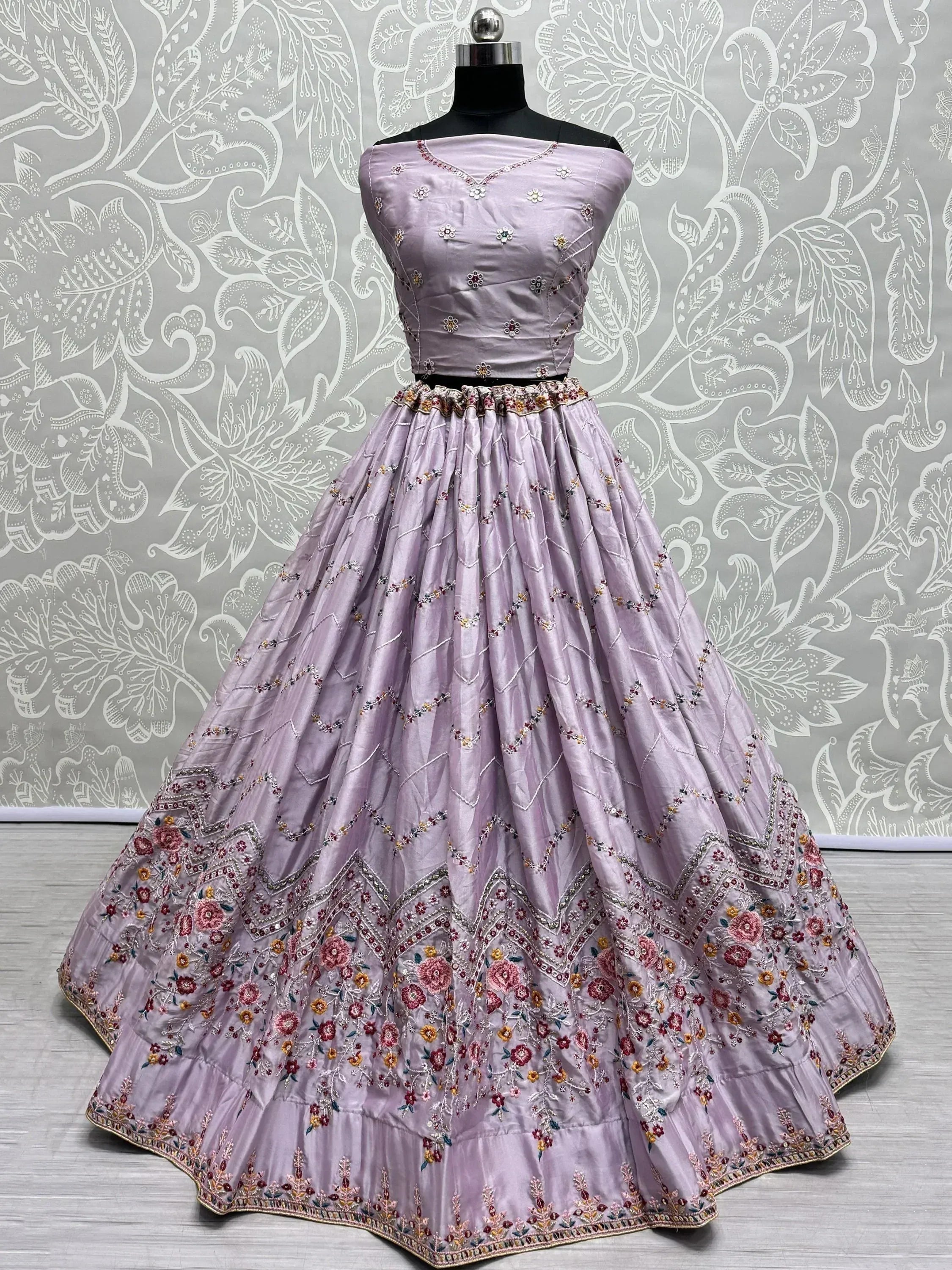 Lavender designer lehenga choli with floral embroidery and off-shoulder blouse, perfect for Indian ethnic wear occasions.