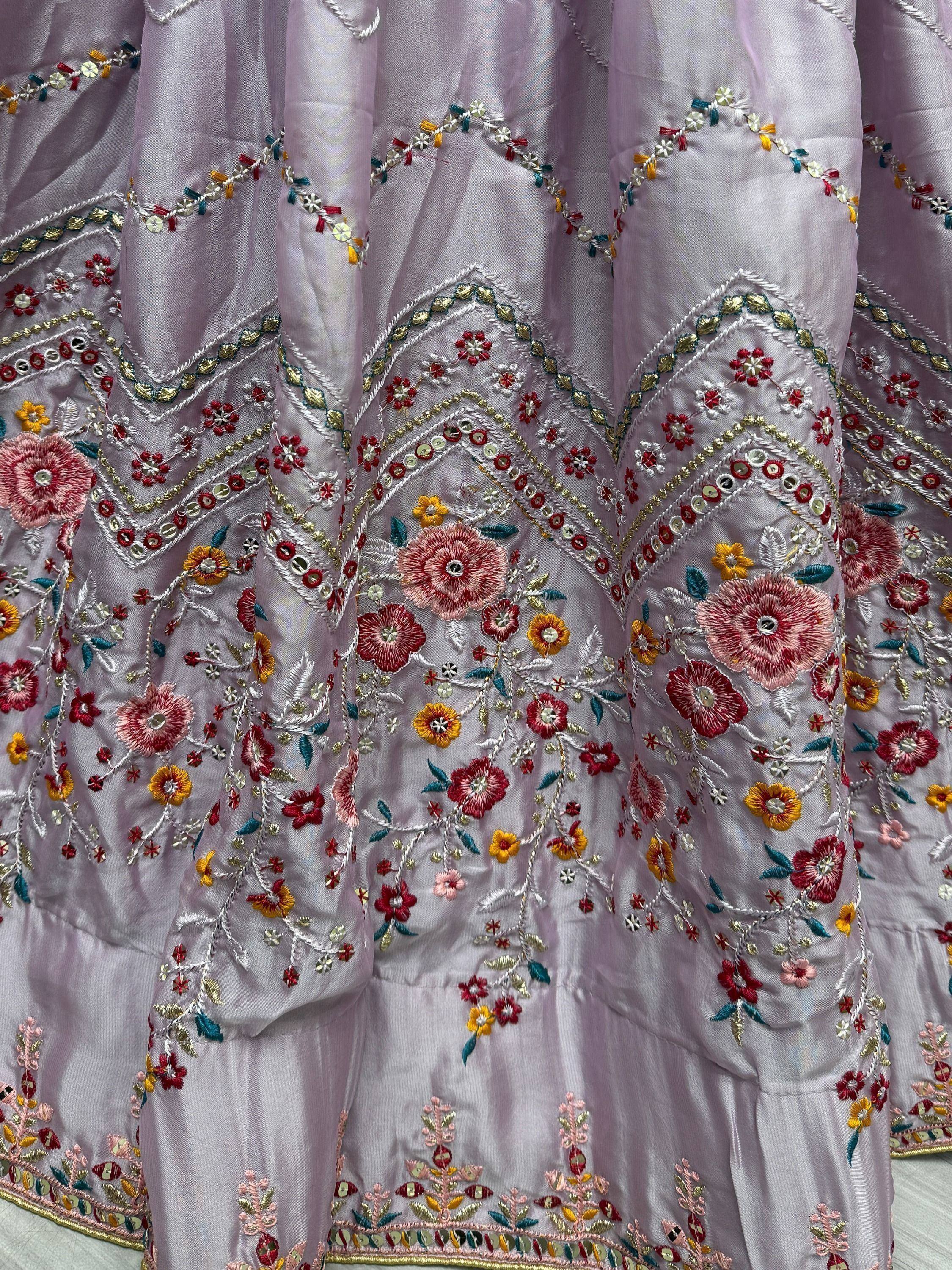 Lavender ethnic gown with floral embroidery and mirror work, perfect for Indian occasions.