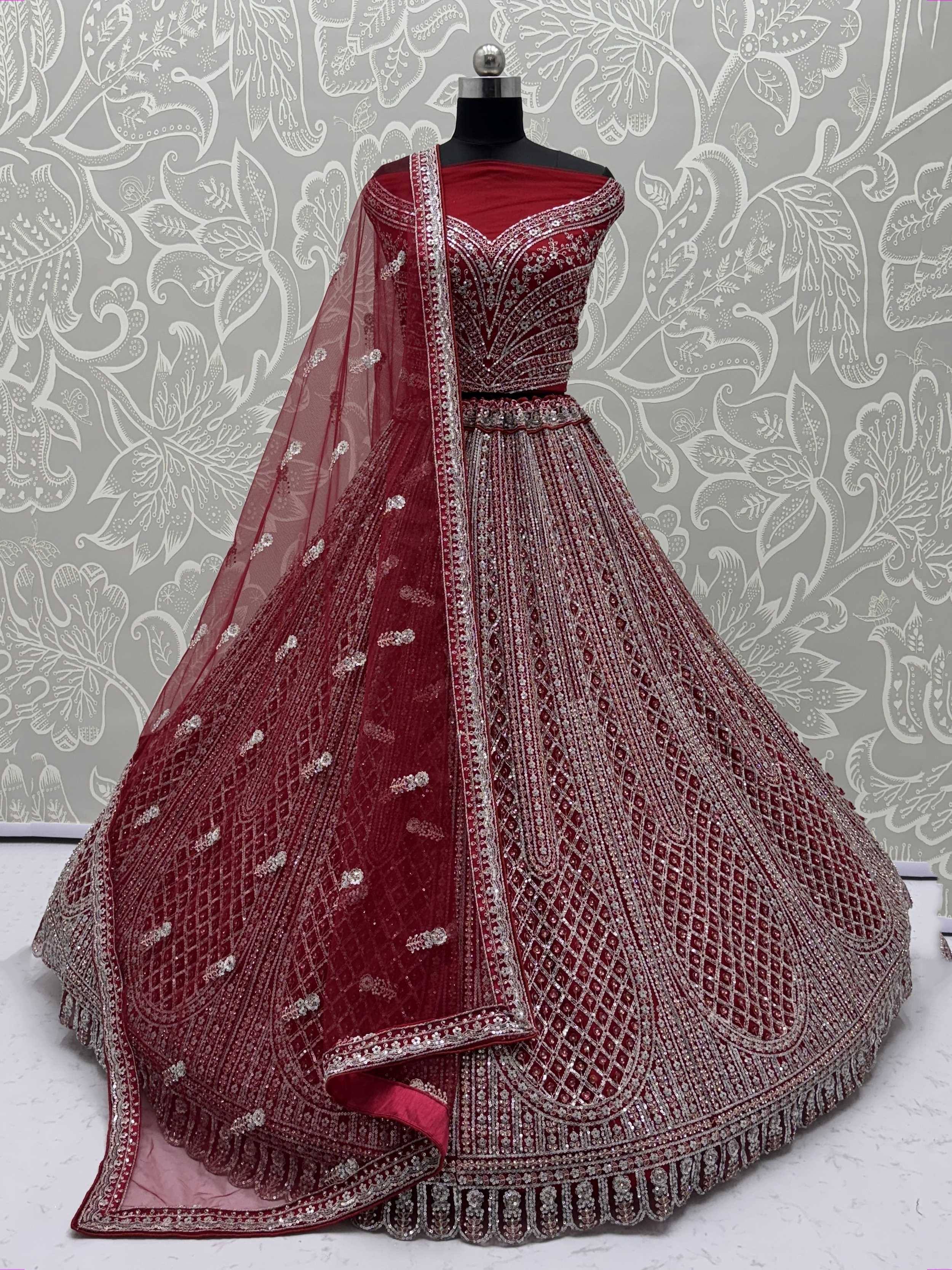 Maroon designer lehenga choli with heavy silver embroidery and net dupatta, perfect for weddings and festive occasions.