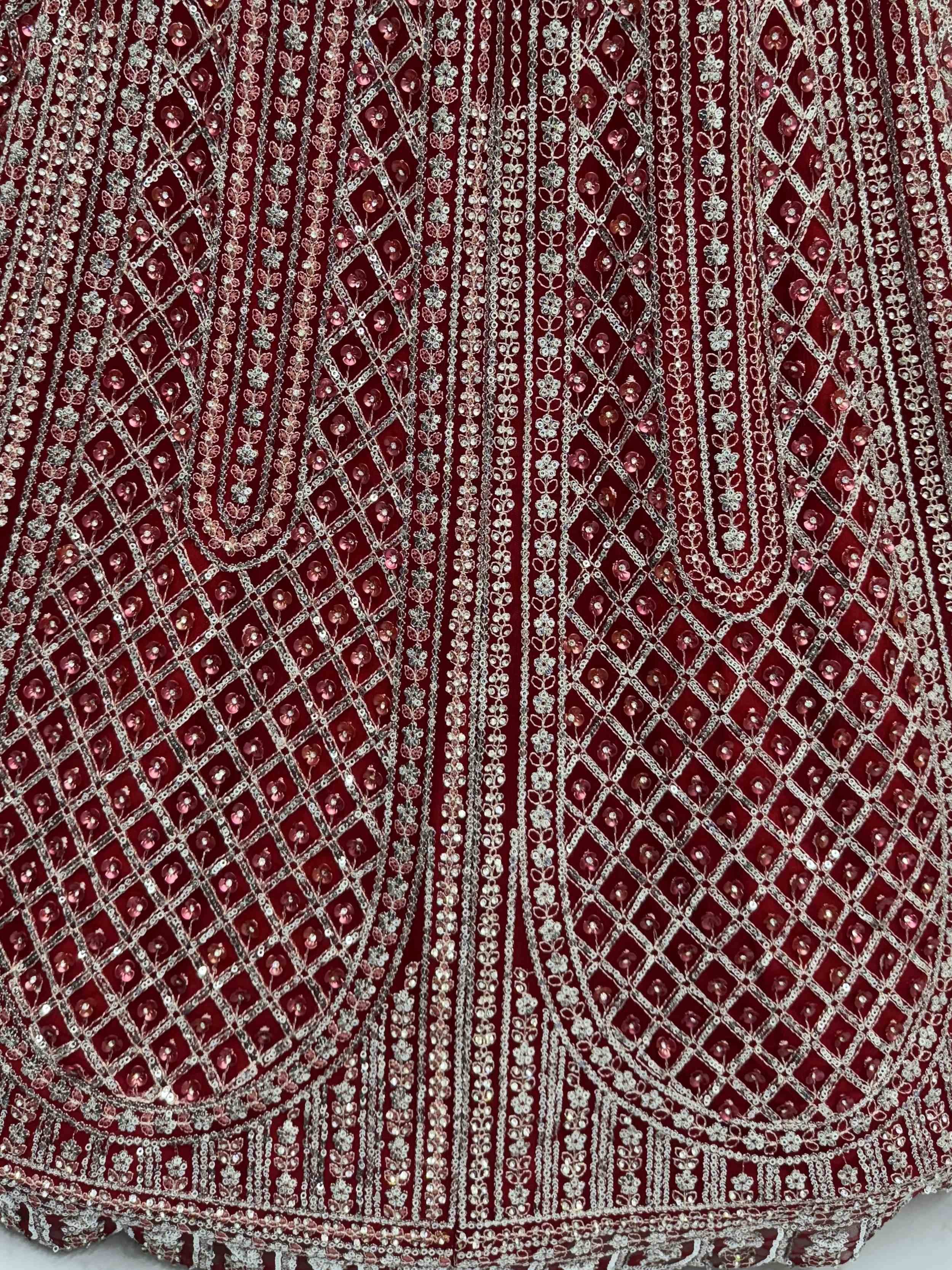 Rich maroon ethnic wear fabric with intricate silver sequin and bead embroidery, perfect for designer lehengas or gowns.