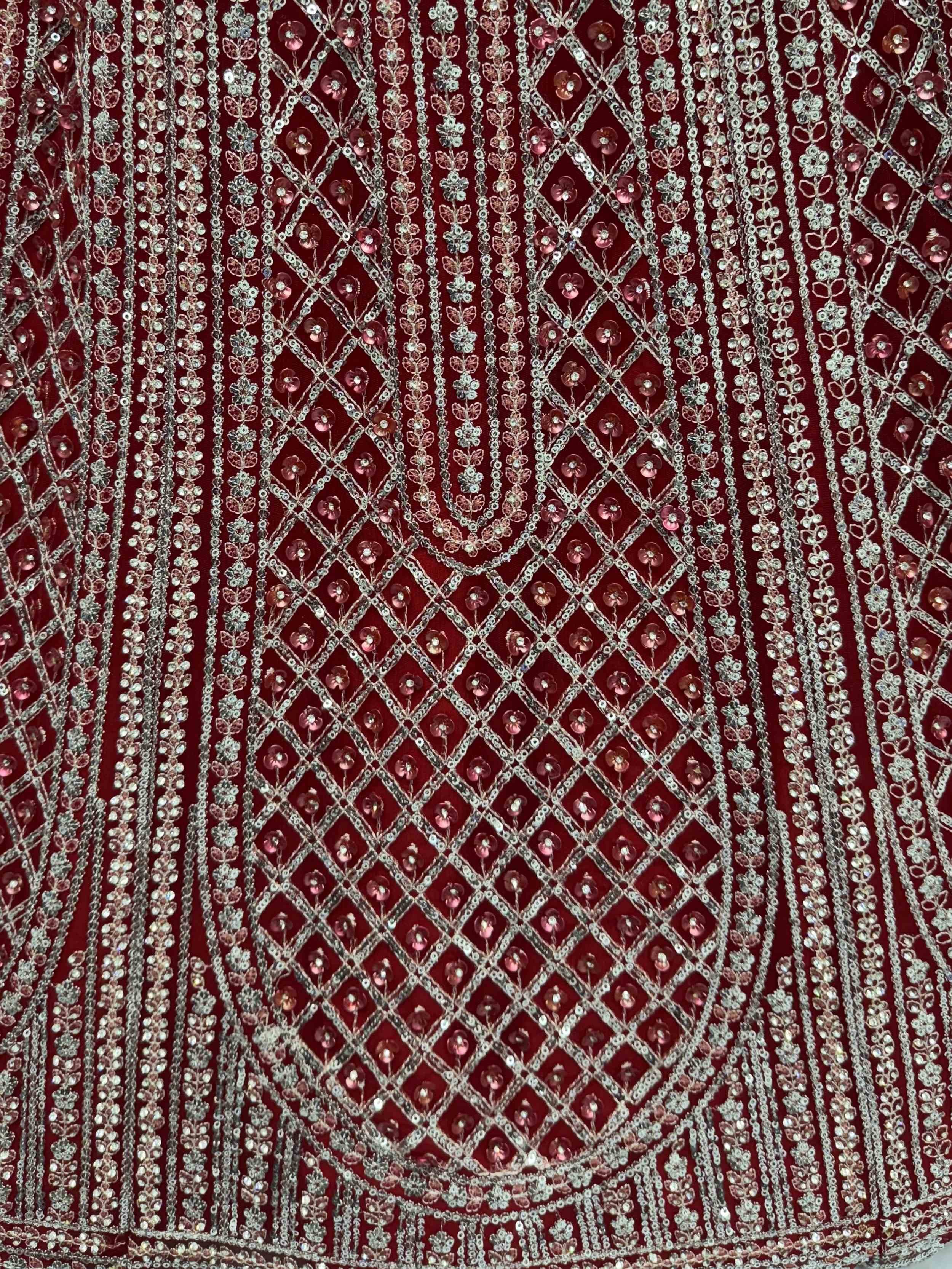 Rich maroon ethnic fabric with intricate silver and pink sequin embroidery, perfect for designer lehenga or saree.