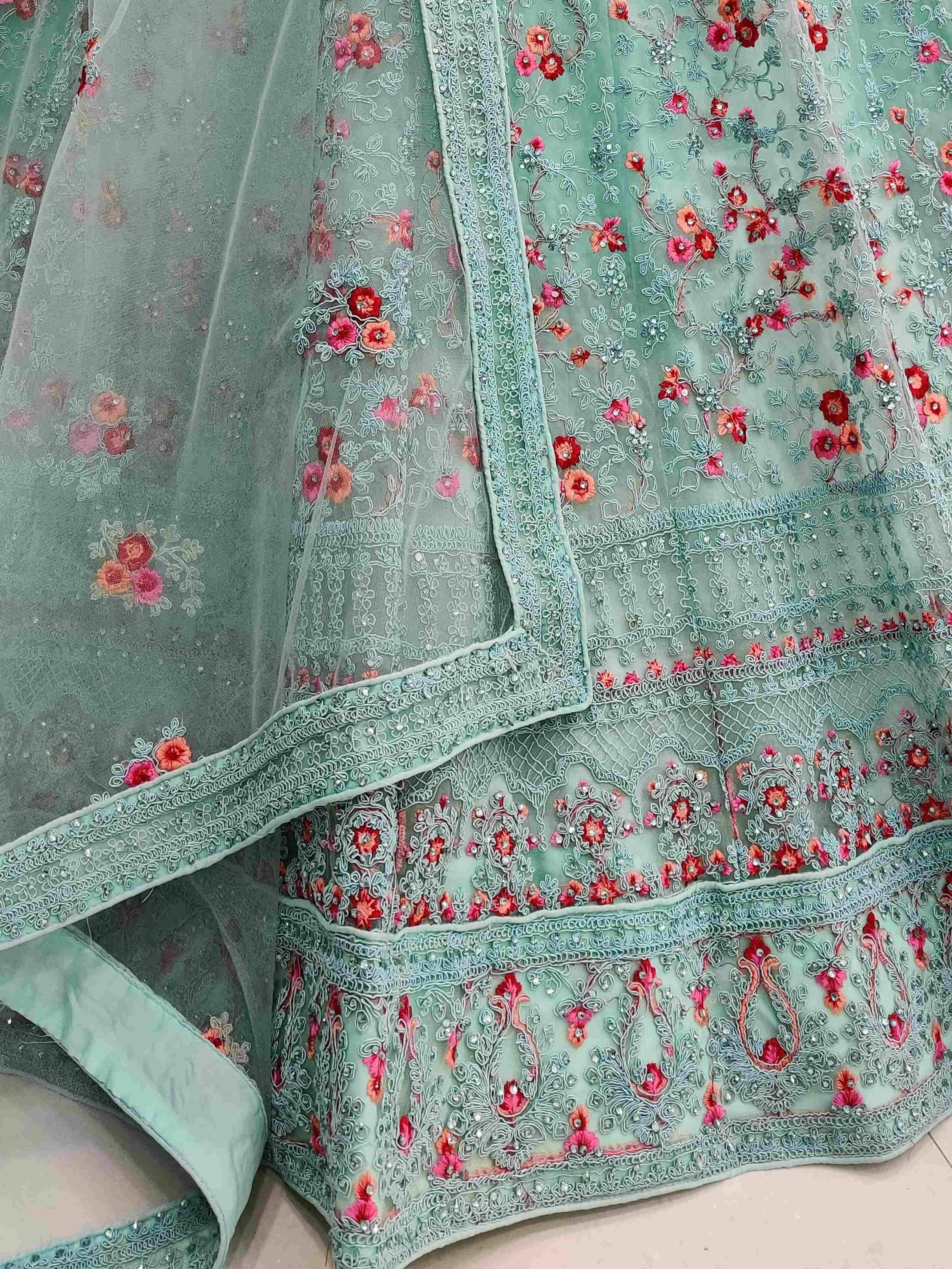 Mint green embroidered lehenga choli with floral motifs and sequin detailing, perfect for Indian ethnic wear.
