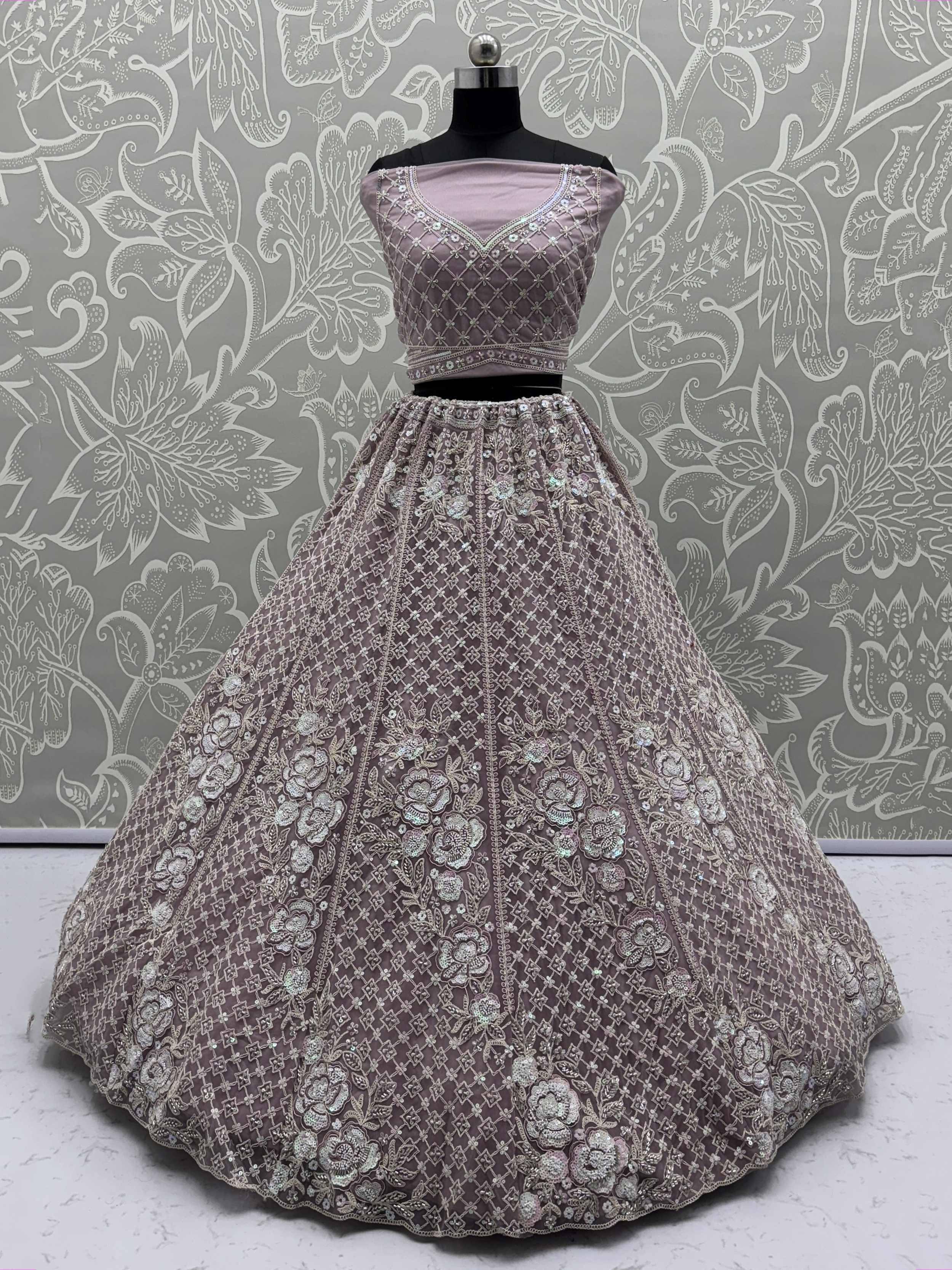 Elegant mauve lehenga choli with intricate floral embroidery and sequin work, perfect for Indian ethnic occasions.
