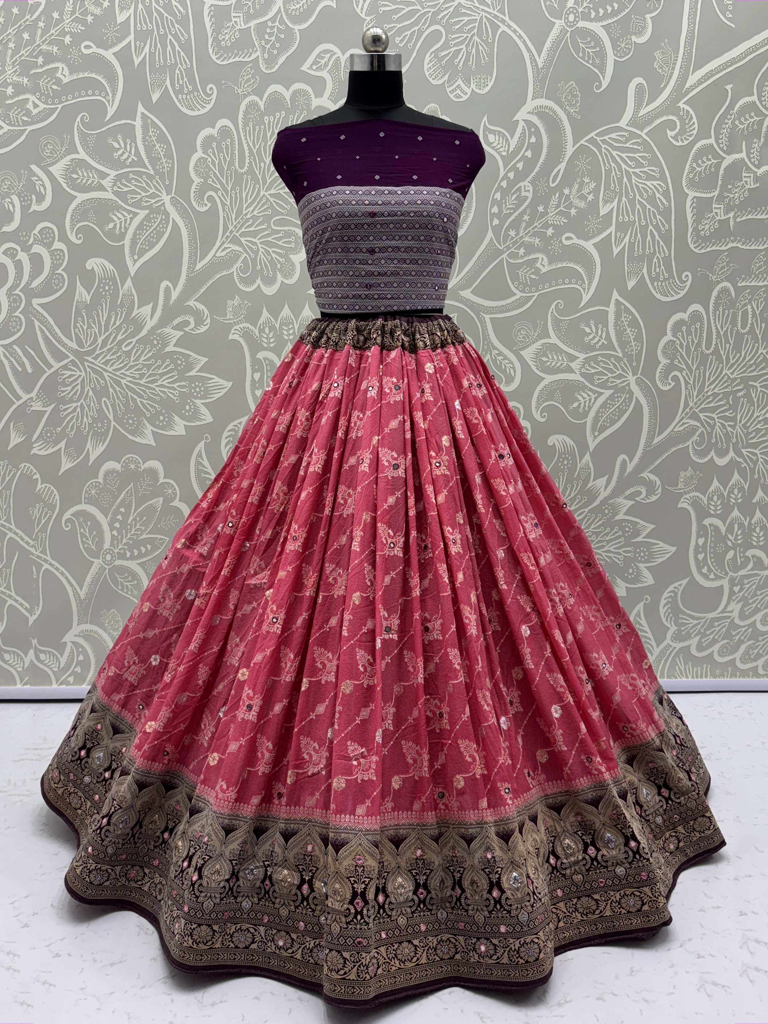 Purple and pink designer lehenga choli with intricate embroidery and embellished border, perfect for Indian ethnic wear.