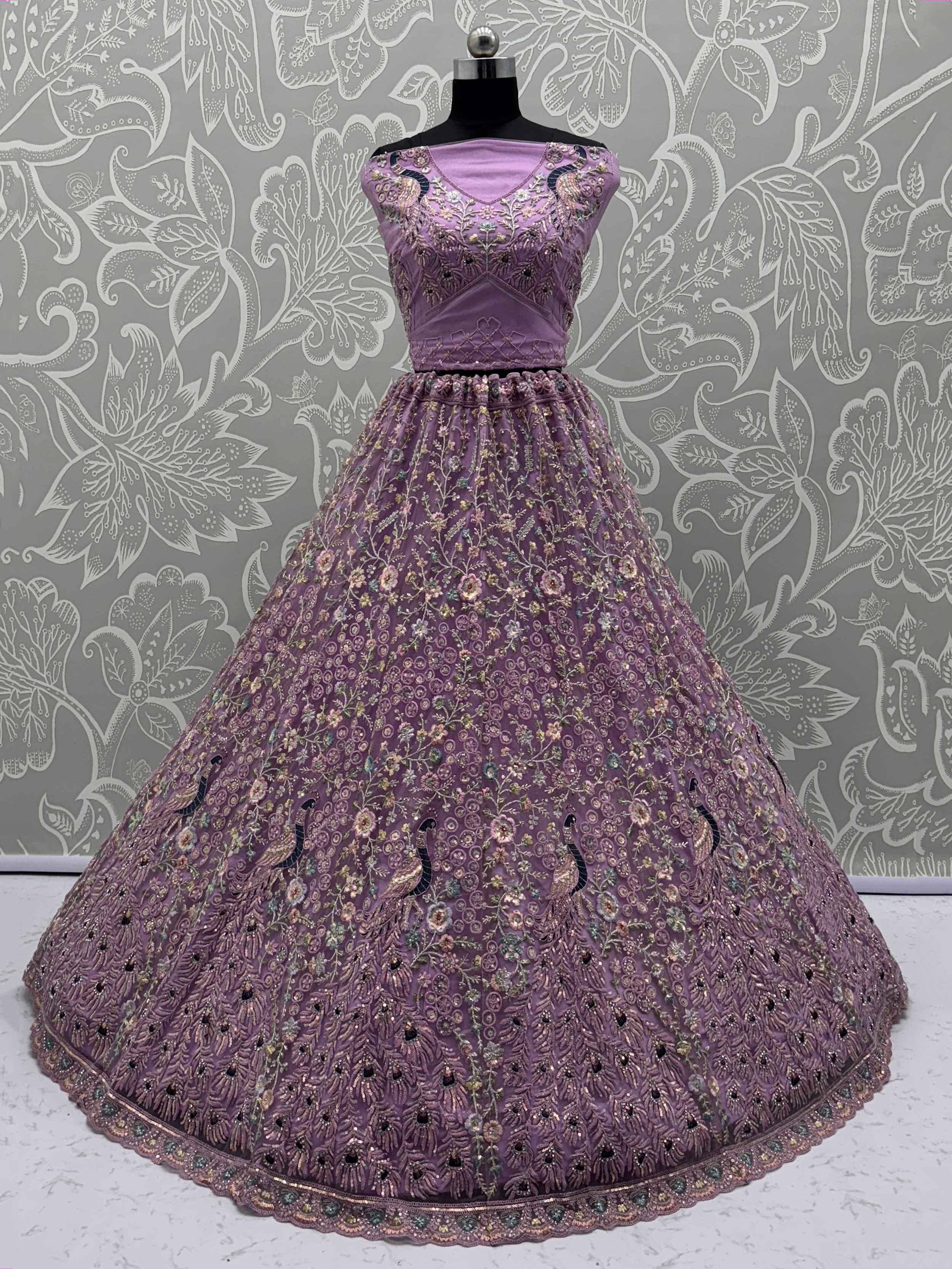 Purple embroidered lehenga choli with peacock motifs, floral work, and net skirt for Indian ethnic wear