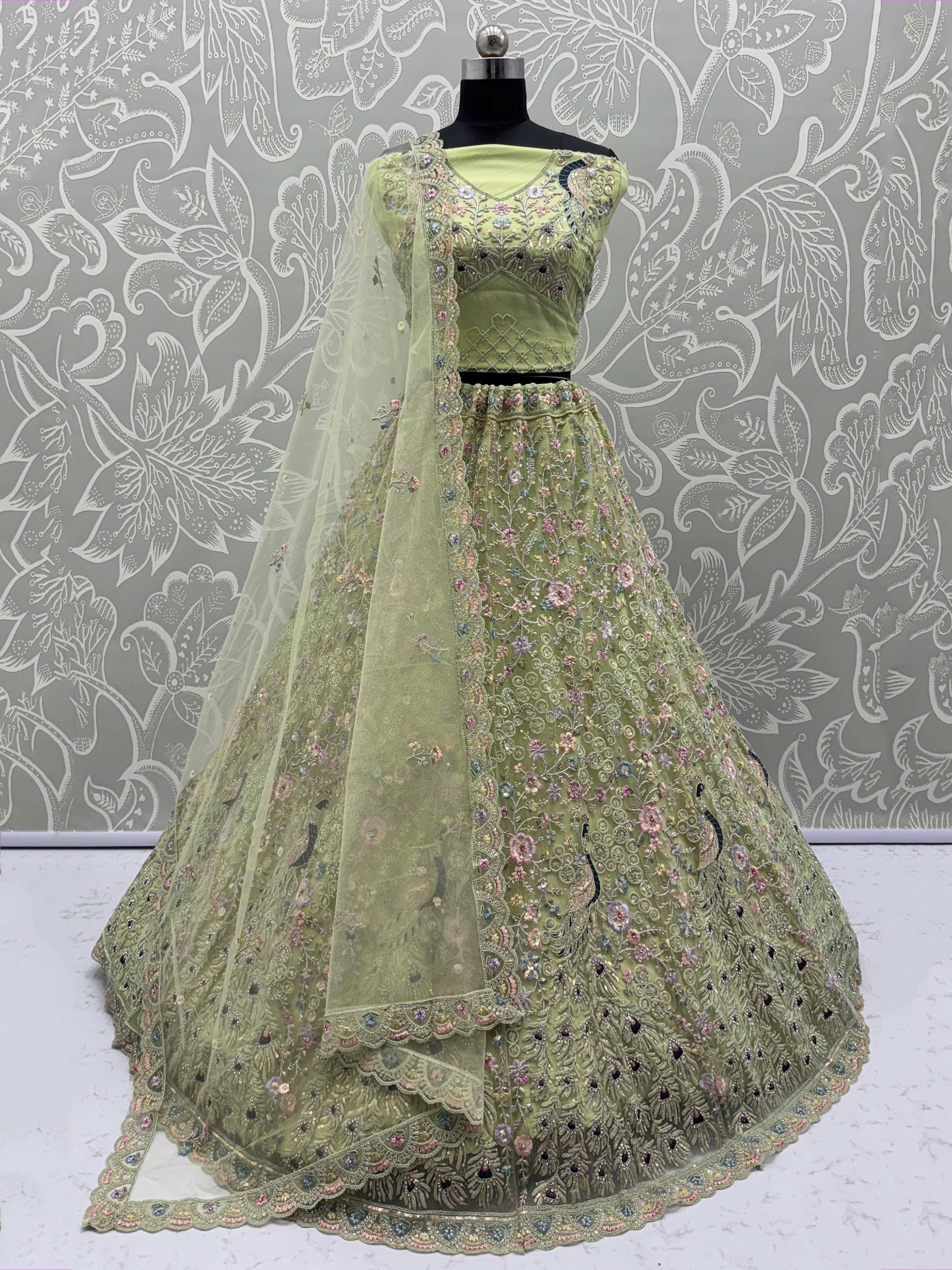 Light green embroidered lehenga choli with floral and peacock motifs, perfect for Indian ethnic wear occasions.