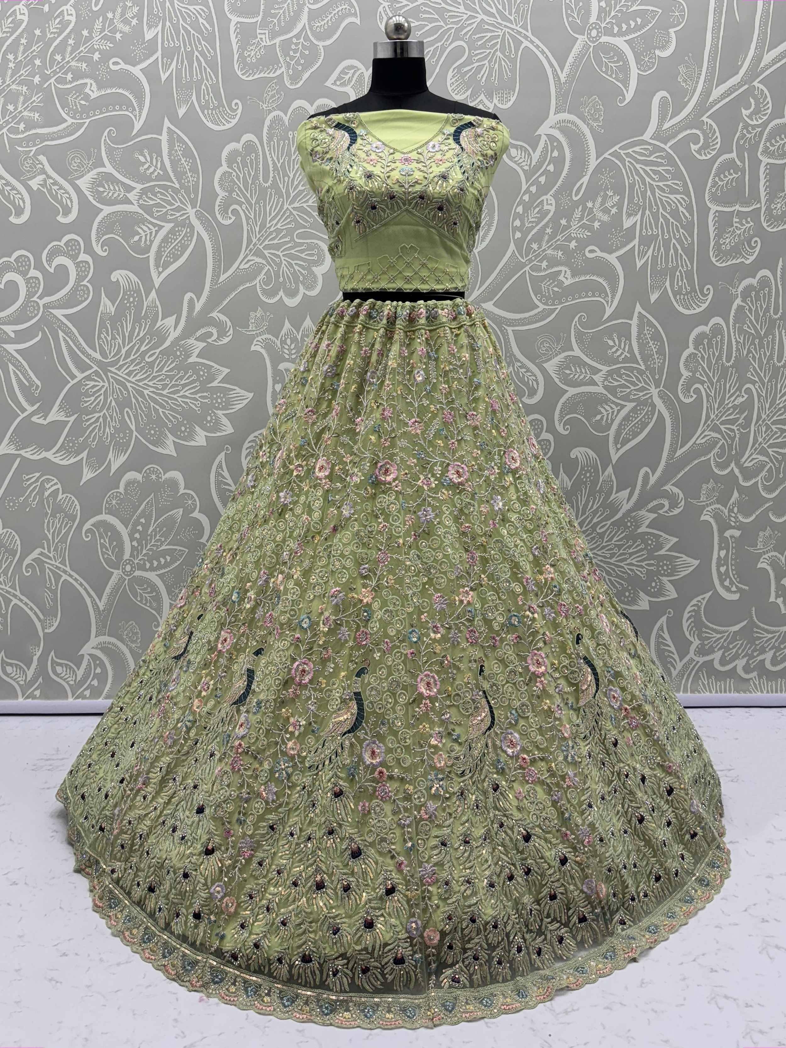 Light green embroidered lehenga choli with floral and peacock motifs, perfect for Indian ethnic wear occasions.