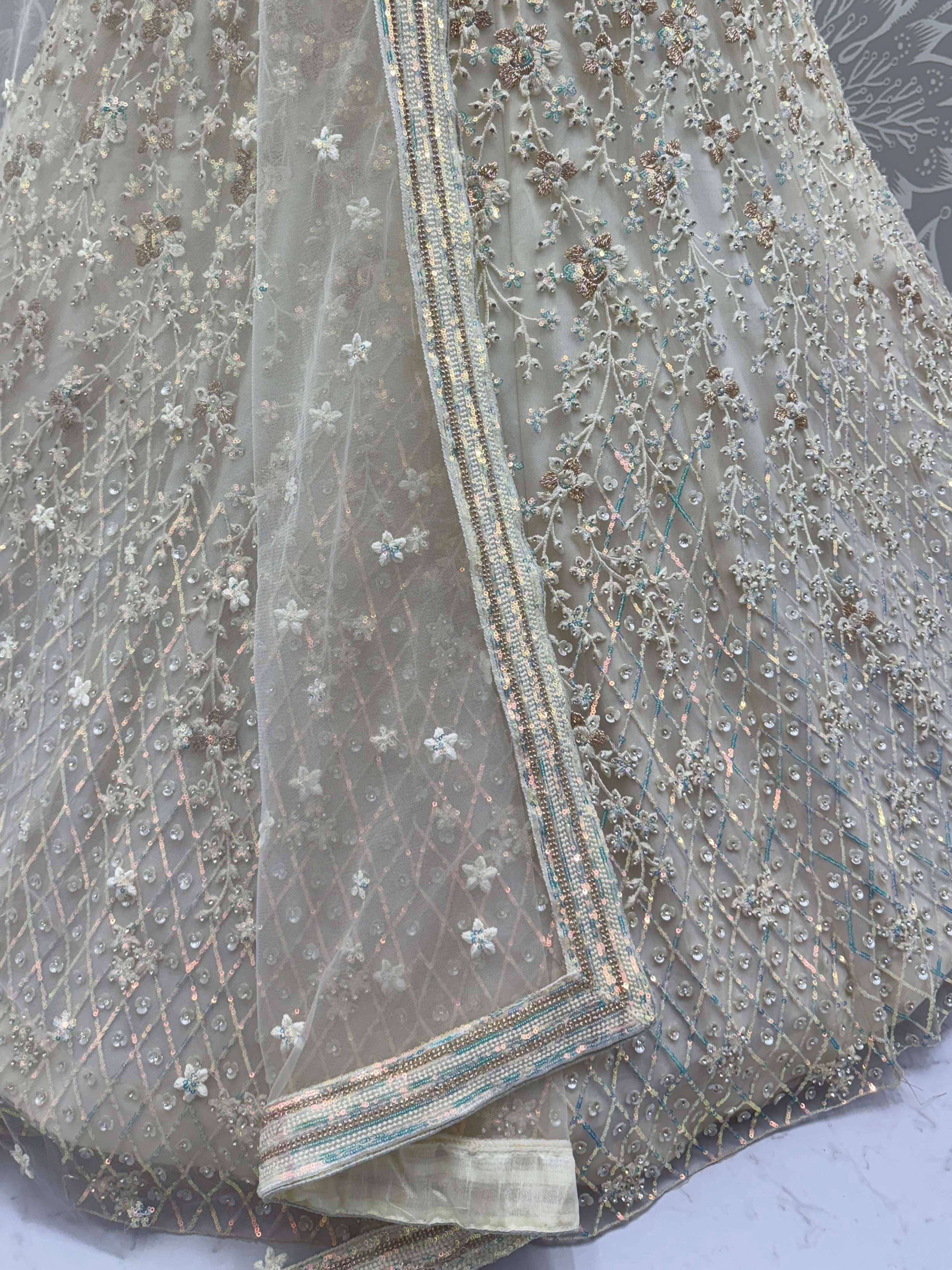 Elegant grey net lehenga with intricate floral embroidery, sequins, and beaded border for Indian ethnic wear.
