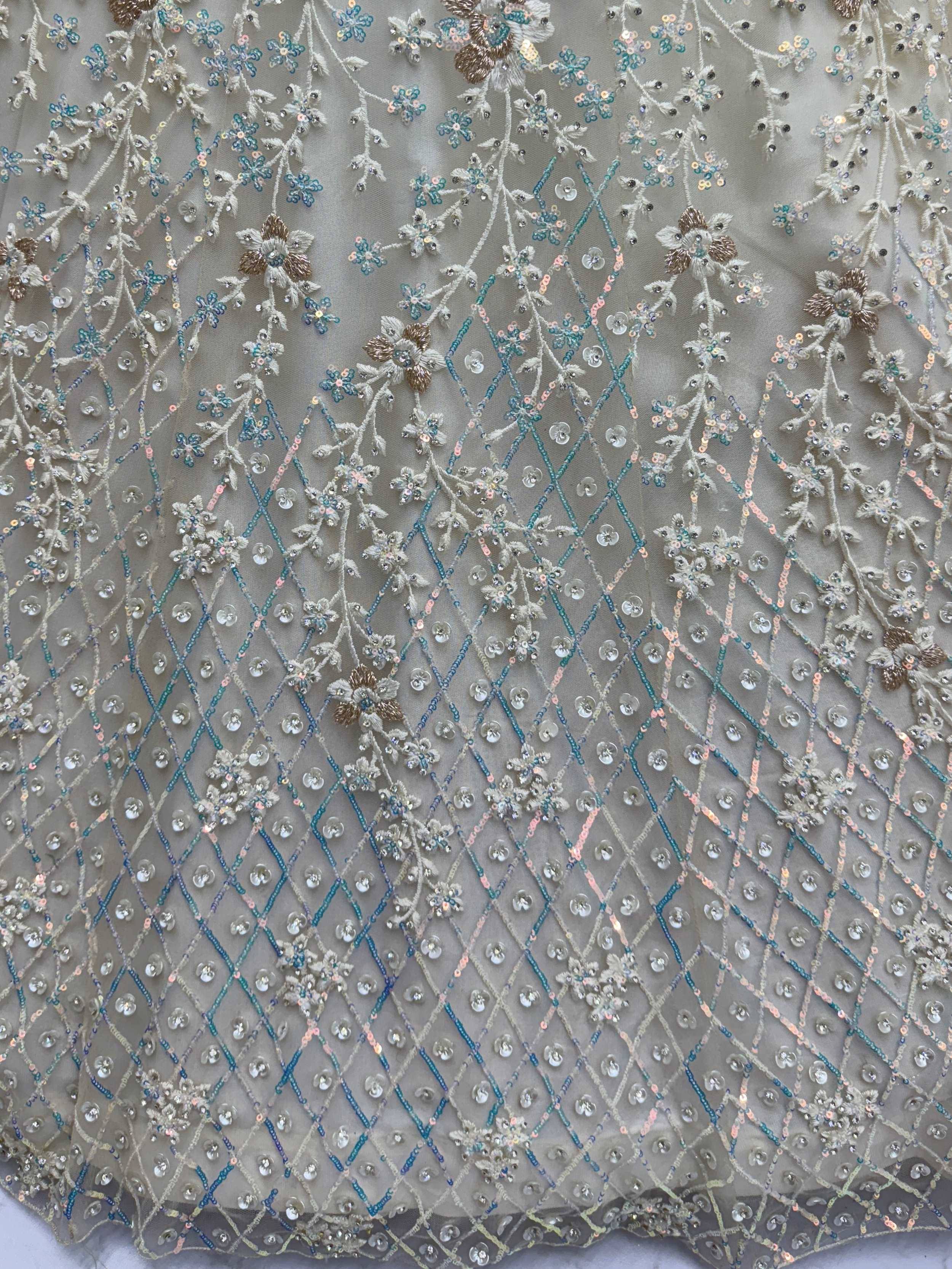 Elegant floral embroidery with sequins and beads on sheer fabric, perfect for designer lehenga choli or ethnic gown.