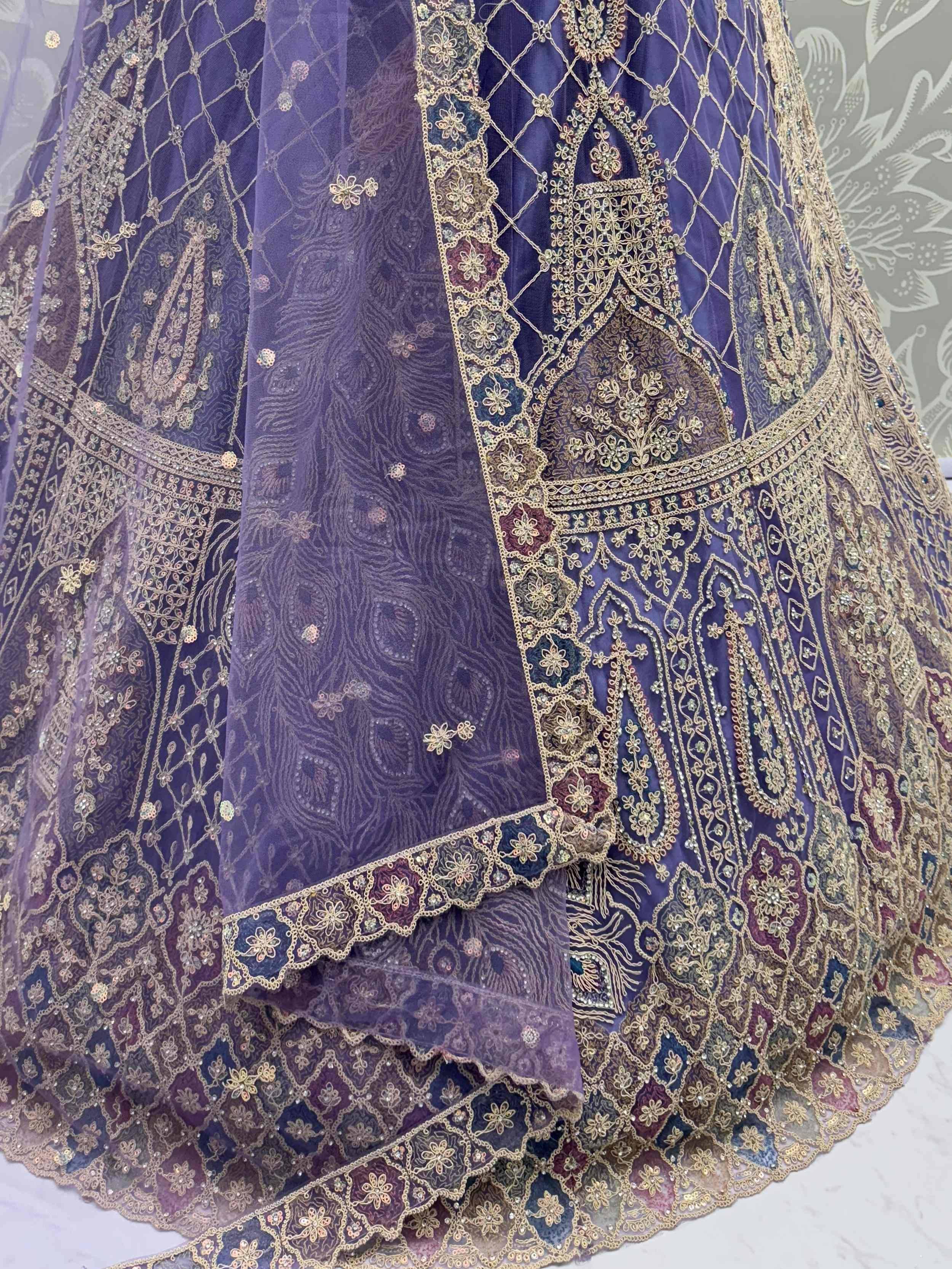 Purple designer lehenga choli with gold embroidery and peacock motifs, ethnic Indian wear