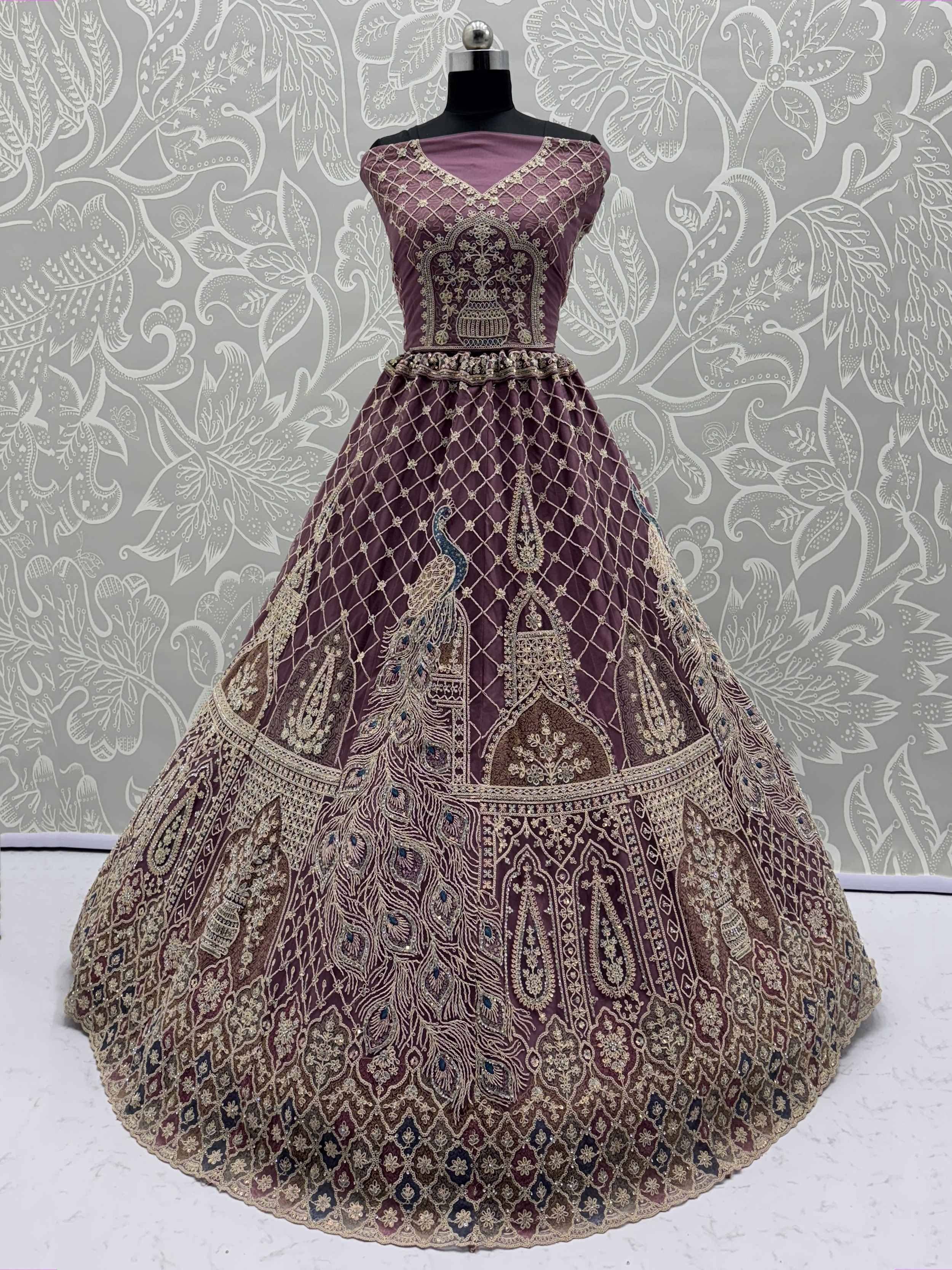 Elegant maroon lehenga with peacock embroidery and gold detailing, perfect for Indian ethnic wear.