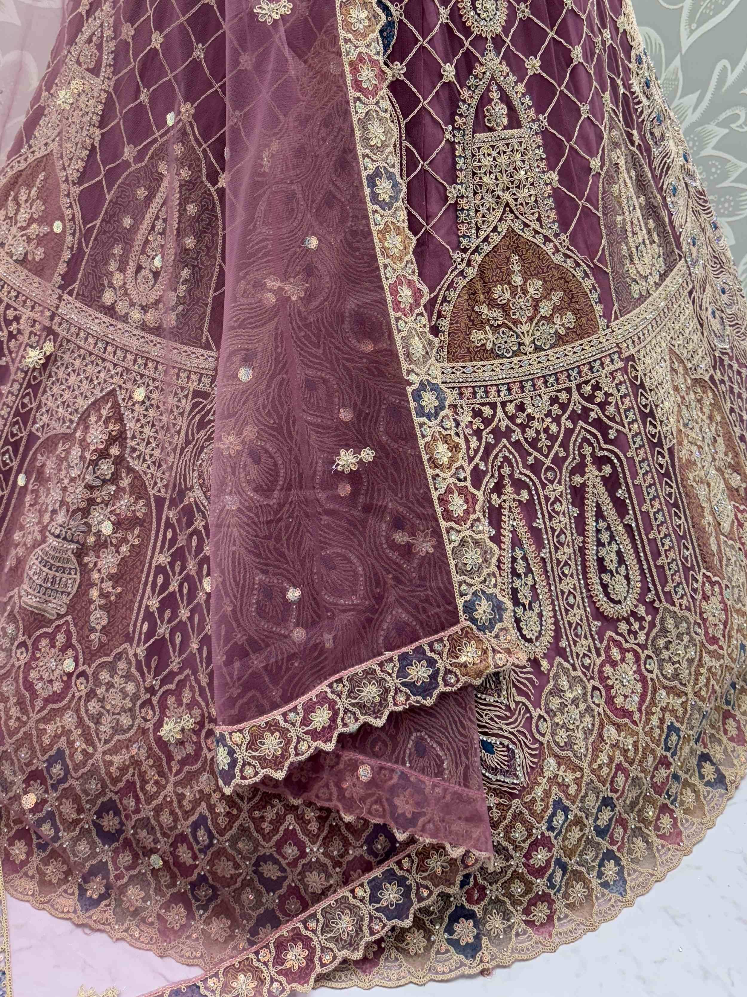 Elegant maroon lehenga with intricate gold embroidery and floral patterns, perfect for Indian ethnic wear.