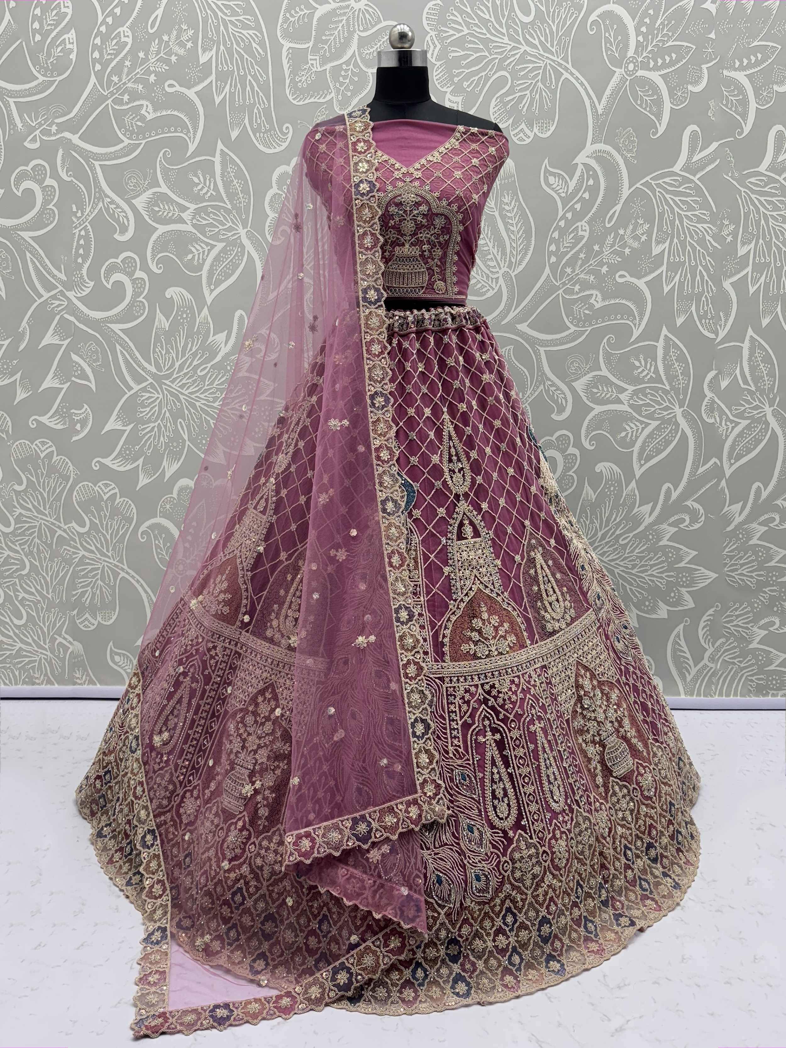 Elegant maroon lehenga choli with gold embroidery and net dupatta, perfect for Indian ethnic wear occasions.