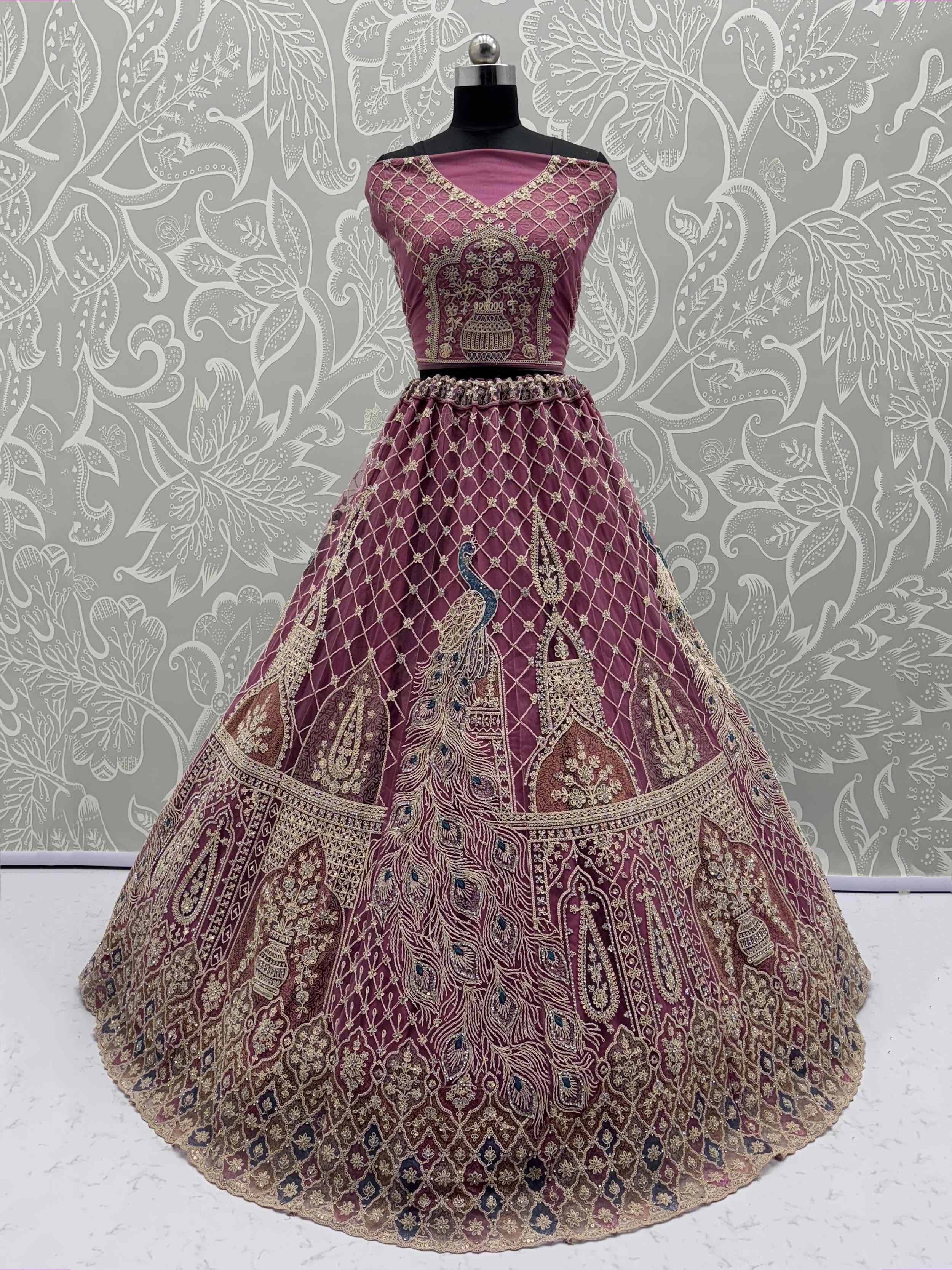 Elegant maroon lehenga choli with intricate gold embroidery and peacock motifs, perfect for Indian ethnic wear.