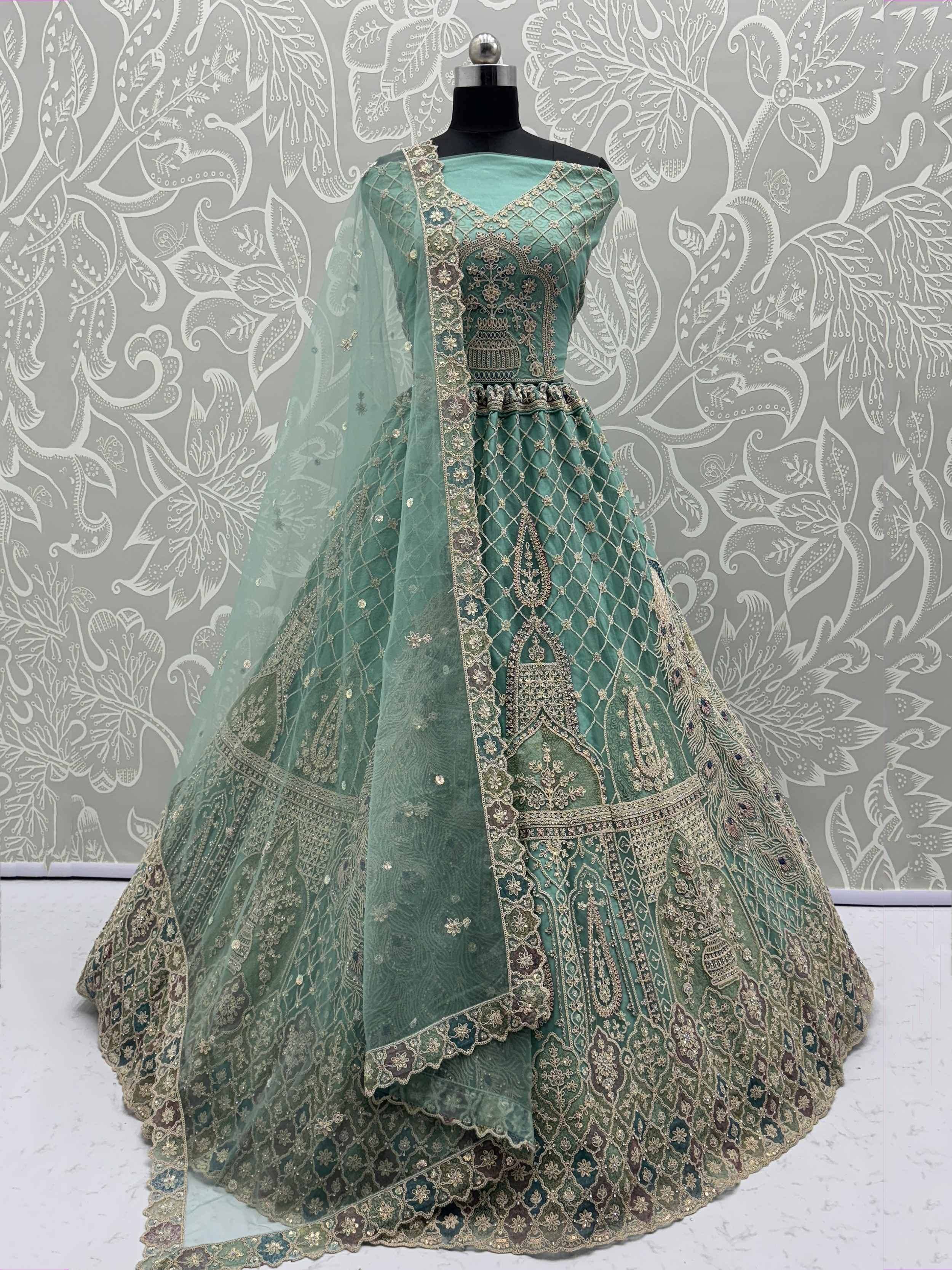 Mint green designer lehenga choli with intricate gold embroidery and net dupatta, perfect for Indian weddings.