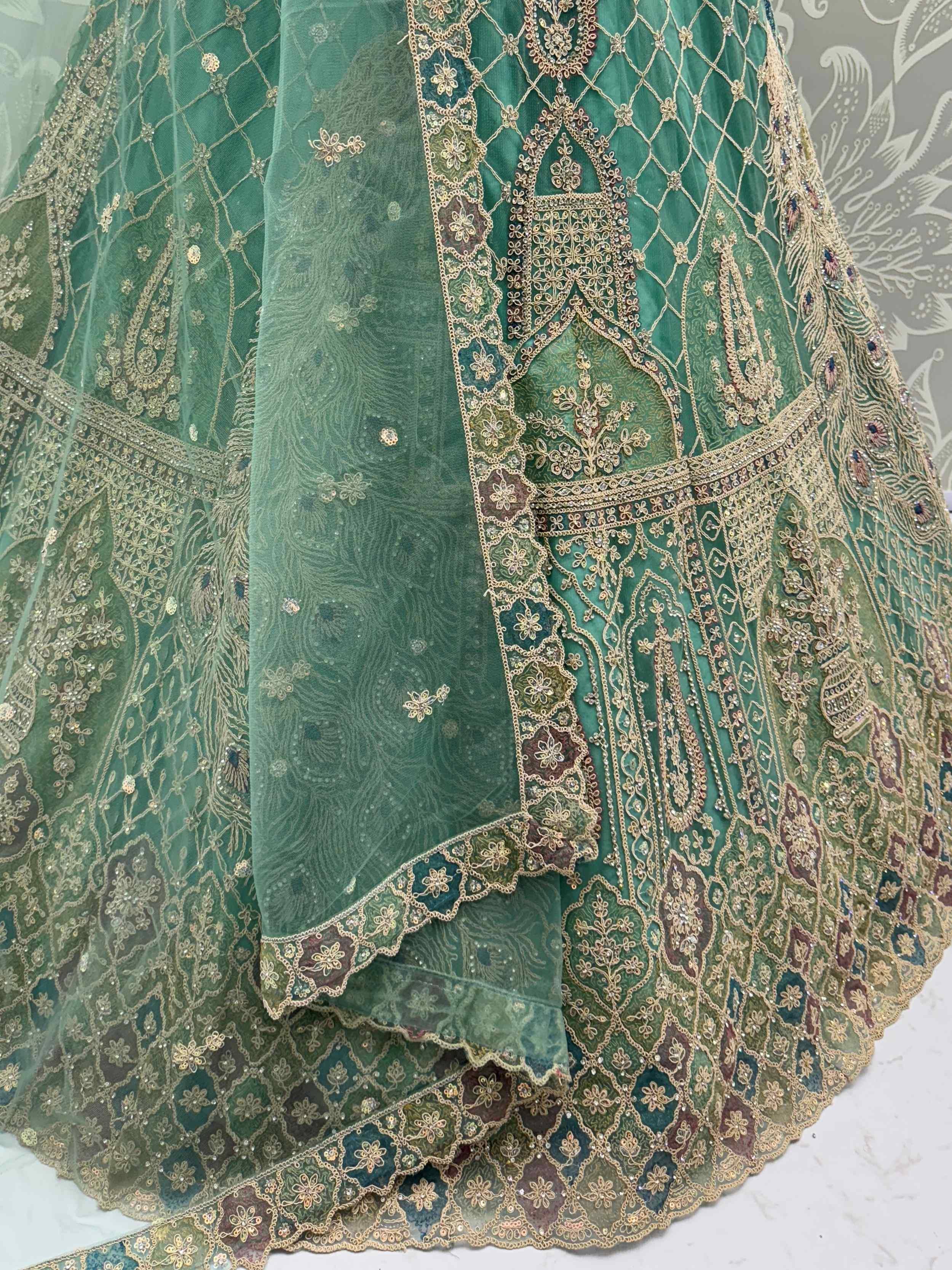 Emerald green designer lehenga with intricate gold embroidery and peacock motifs, perfect for Indian weddings and festive occasions.