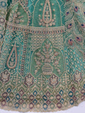 Mesmerizing Green Net Stone Work Reception Wear Lehenga Choli