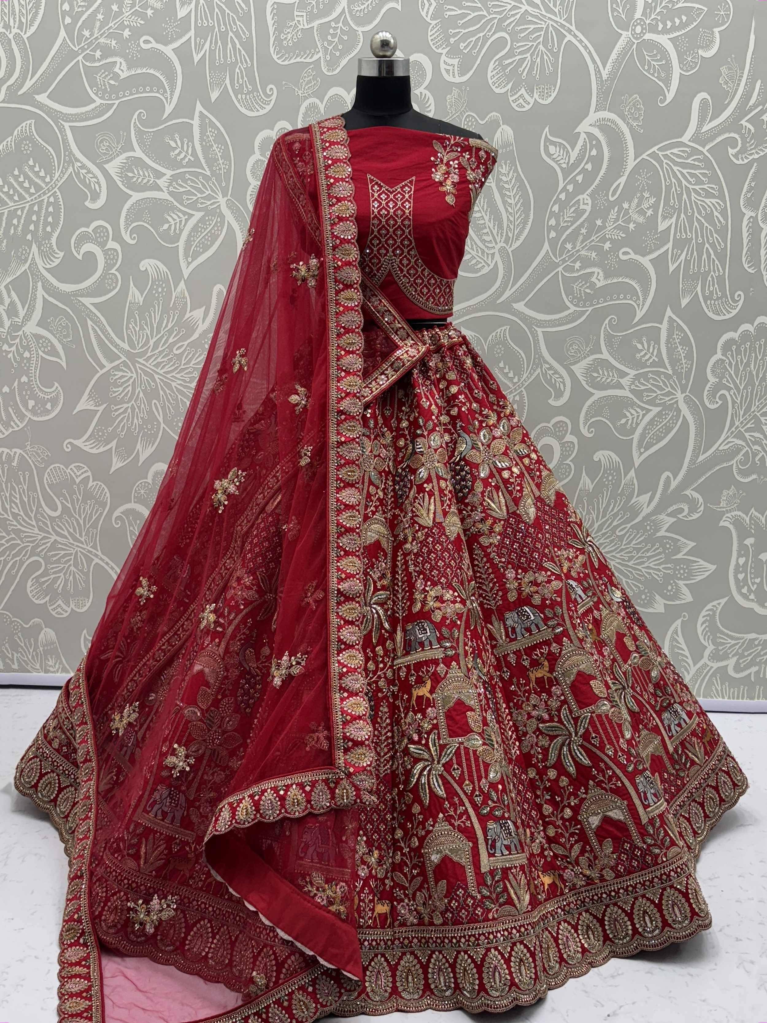Red embroidered lehenga choli with gold detailing, elephant motifs, and sheer dupatta for Indian ethnic wear