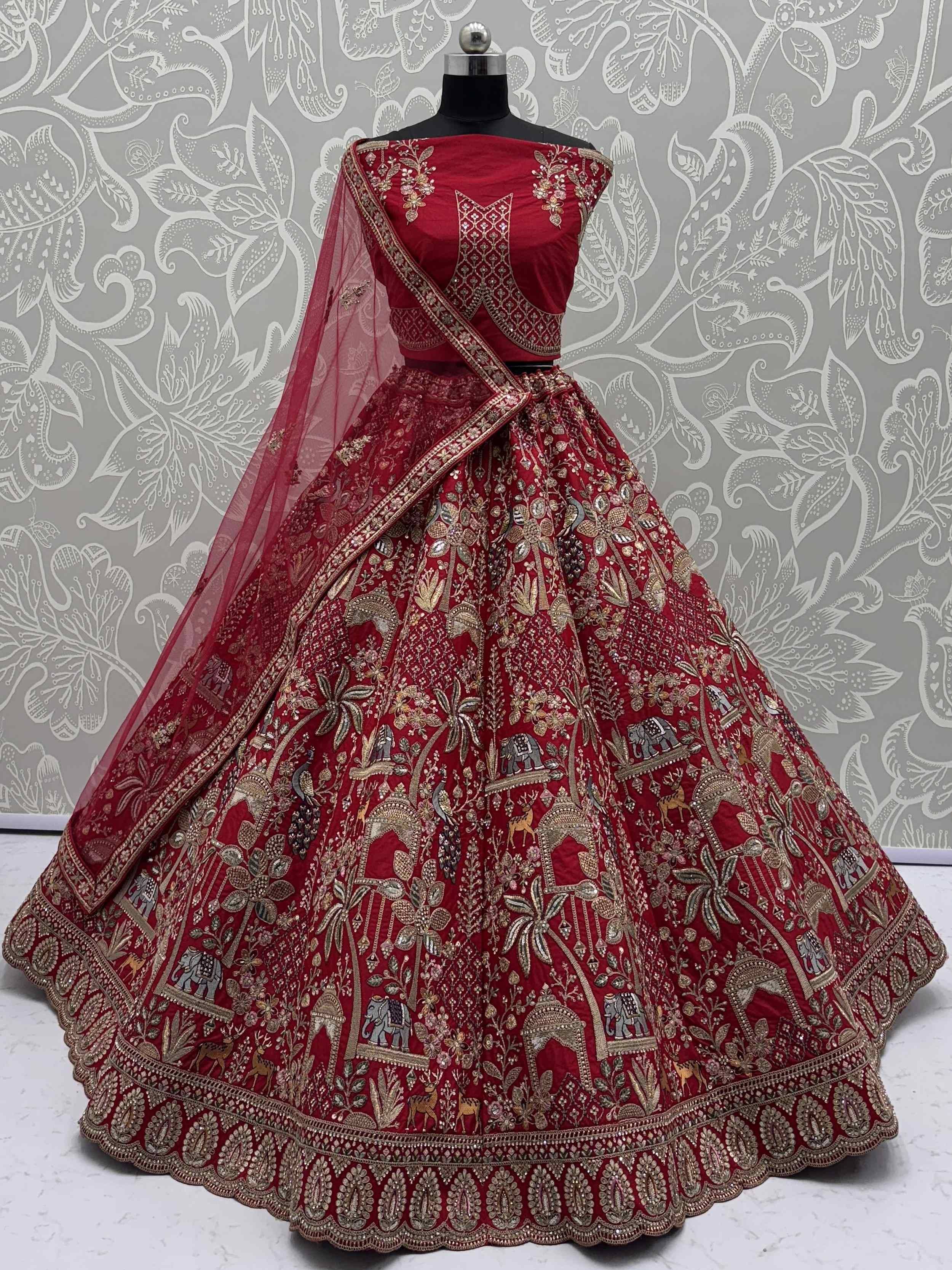 Red embroidered lehenga choli with gold detailing and sheer dupatta for Indian ethnic wear