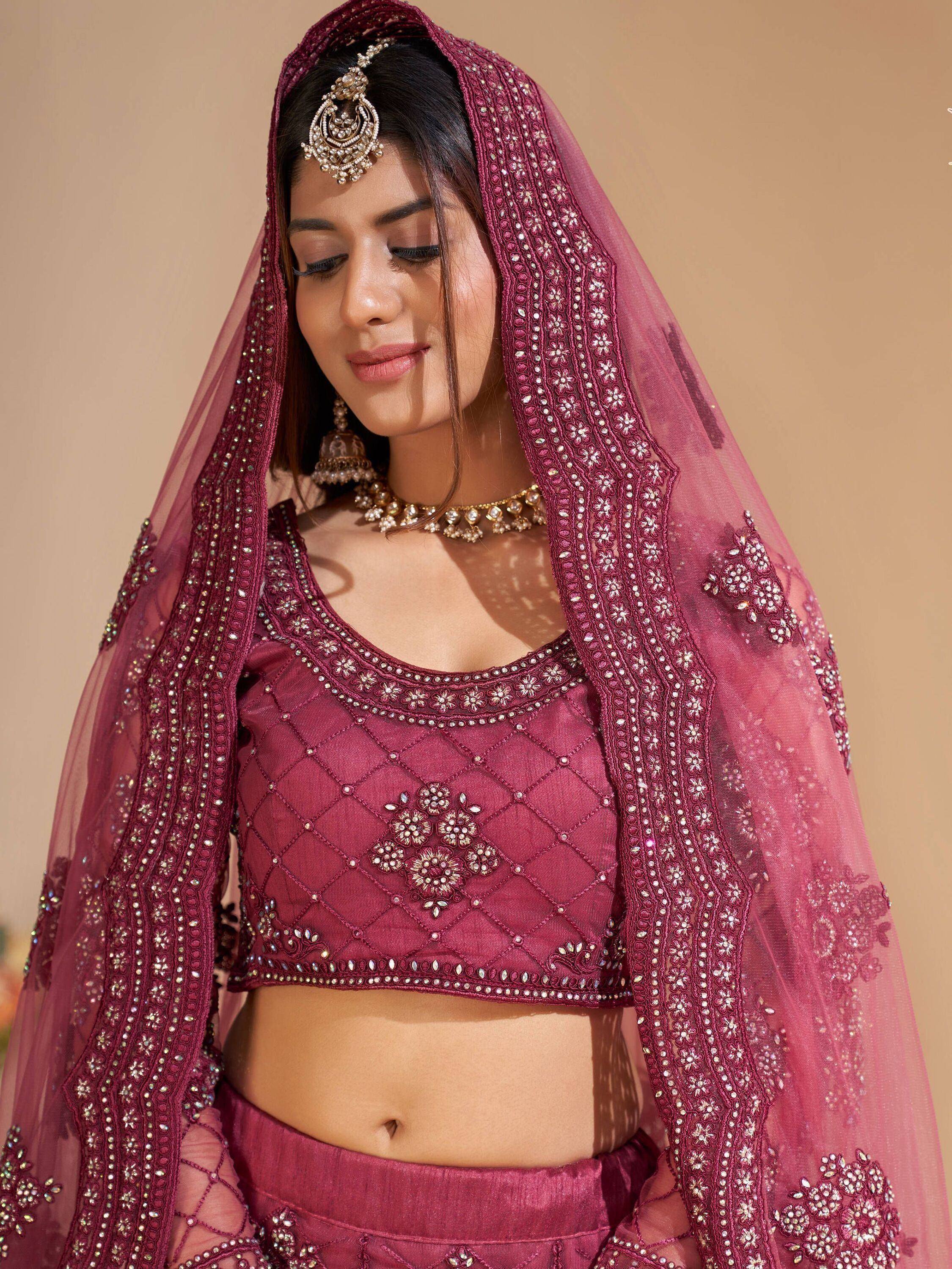 Elegant maroon lehenga choli with intricate embroidery and matching dupatta, perfect for Indian ethnic occasions.